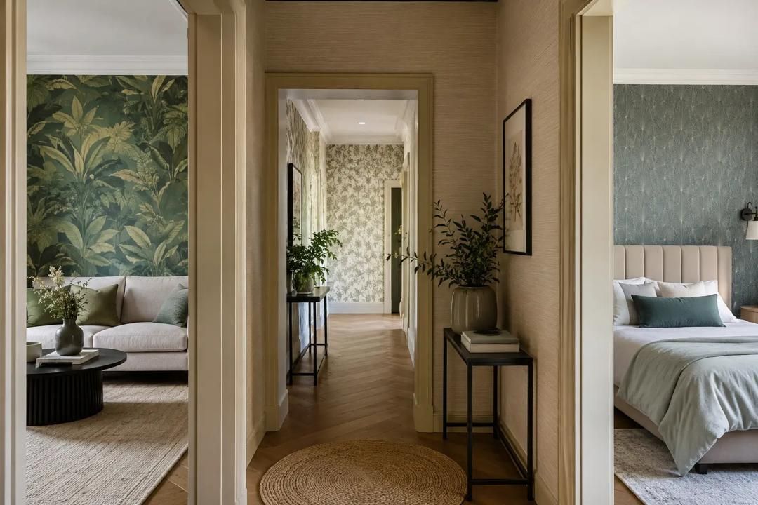 Hallway in a stylish home, with bedrooms on both sides and leafy wallpaper accents.