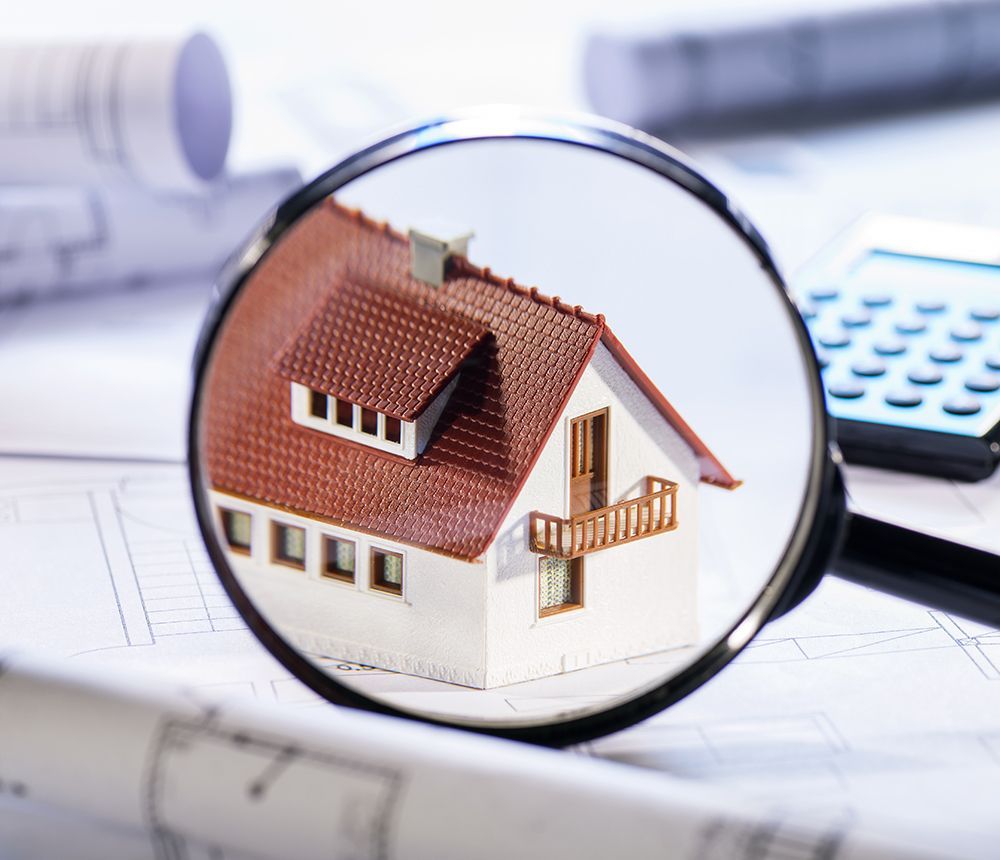 Magnifying Glass And House Model