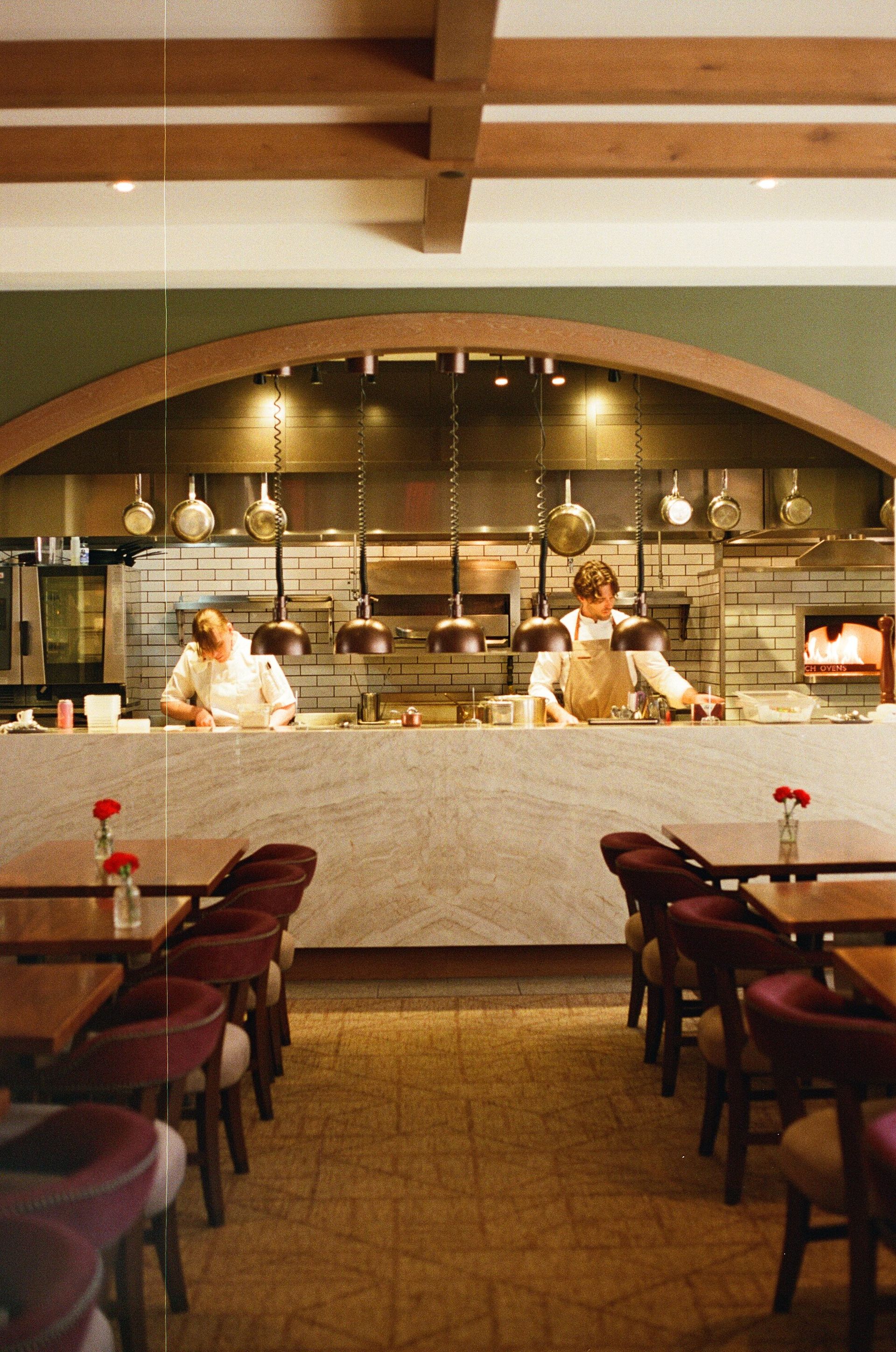 Rooftop restaurant at golden hour with candlelit dinner table in Charleston