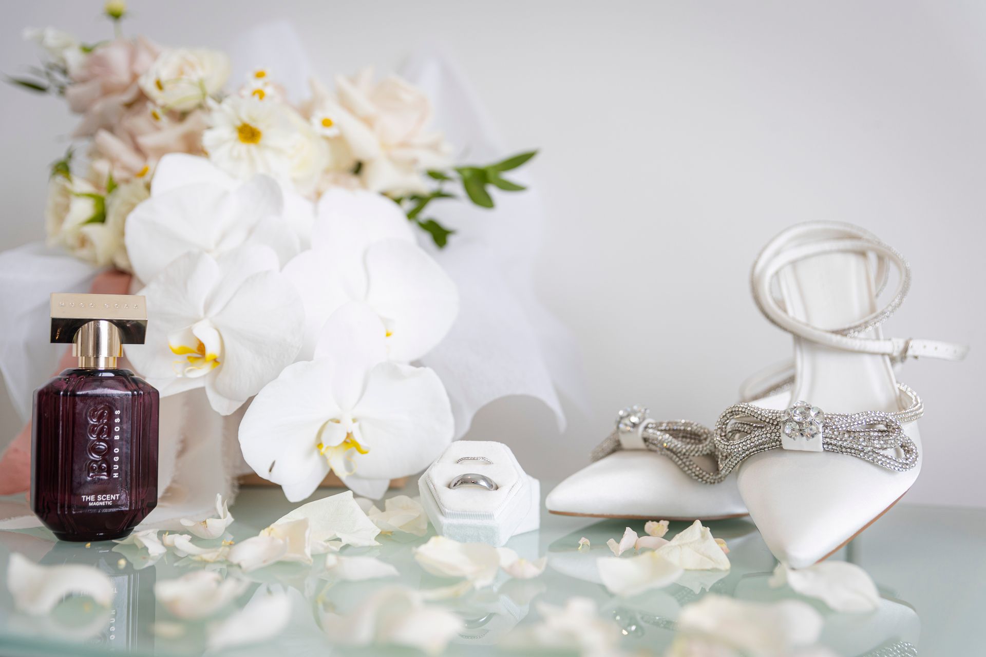 Wedding Video - bottle of perfume , a pair of wedding shoes , and a bouquet of flowers
