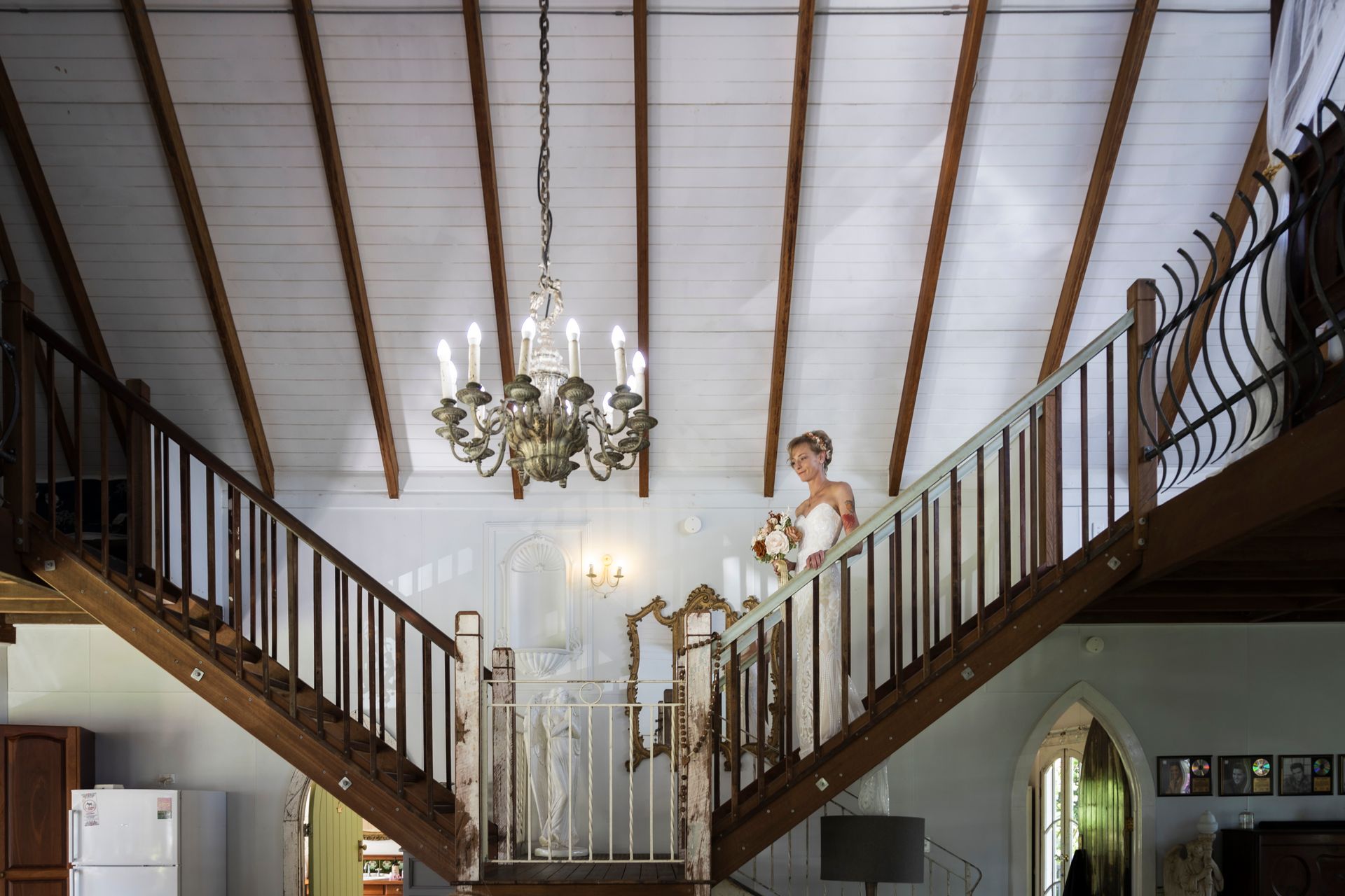 A bride is standing on the stairs of a house. Tamborien Mtn Bridal Preperations