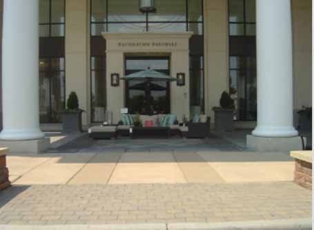 A large building with columns and a patio in front of it.