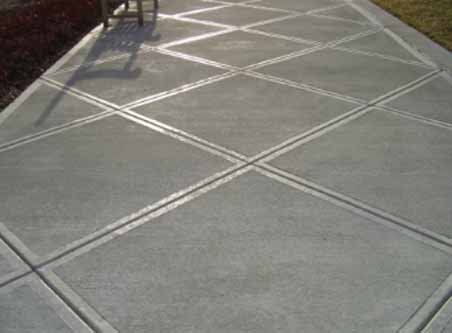 A concrete walkway with a chair in the background.