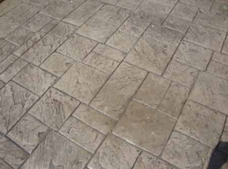 A close up of a brick floor with a pattern.