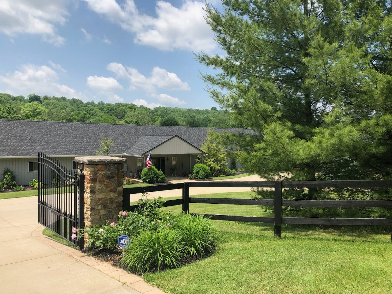 A house with a fence and a gate in front of it