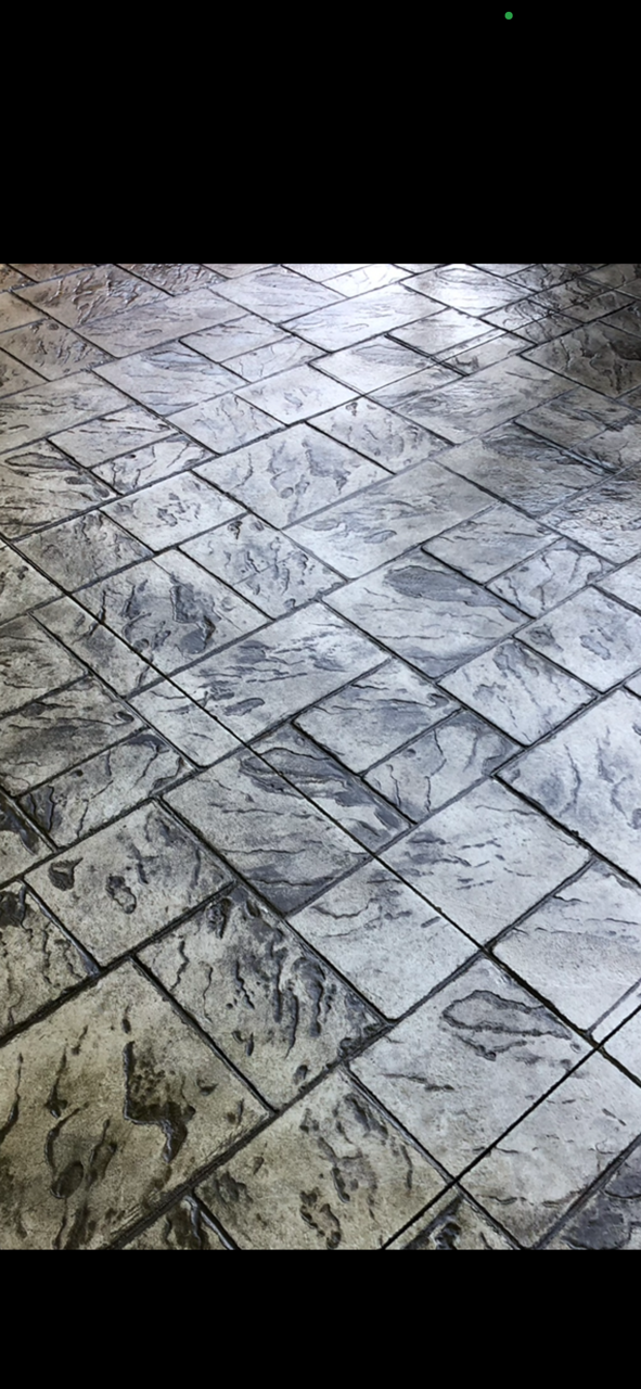 A close up of a tiled floor with a black background.