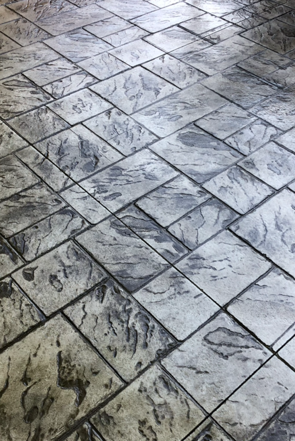 A close up of a gray and white tiled floor.