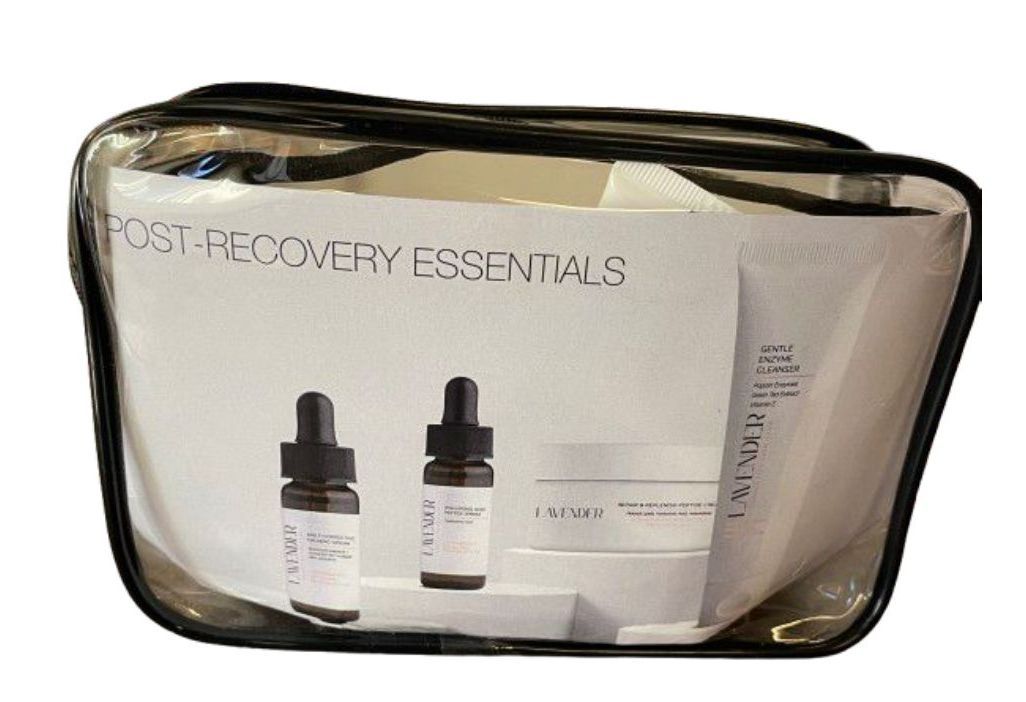 Transparent cosmetics pouch with gold trim holding two dropper bottles and a white card