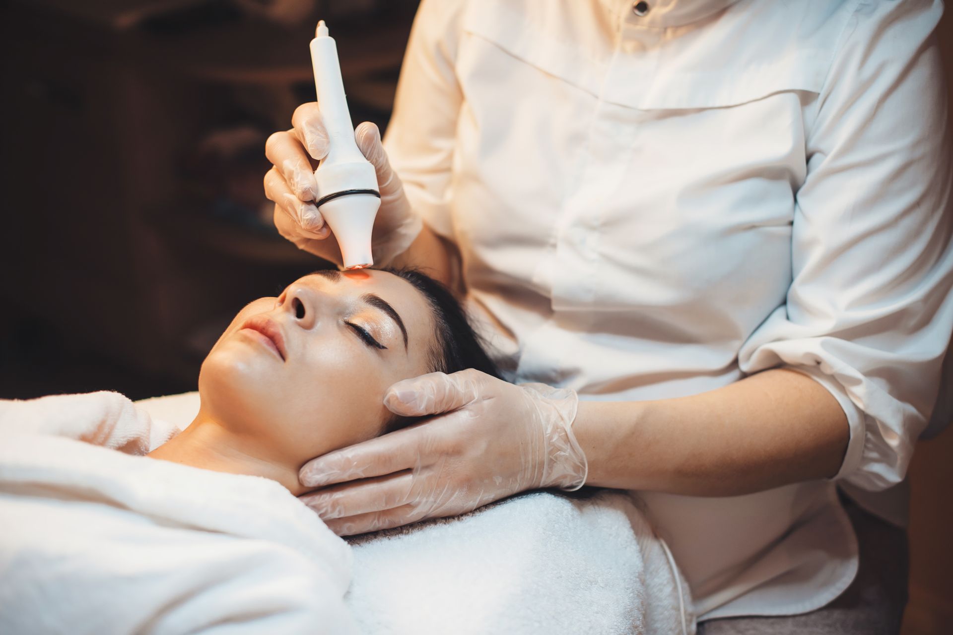 a woman is getting a facial treatment at a beauty salon .