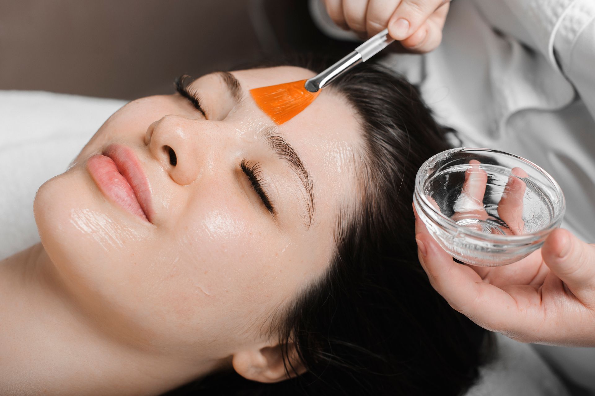 a woman is getting a facial treatment at a beauty salon .