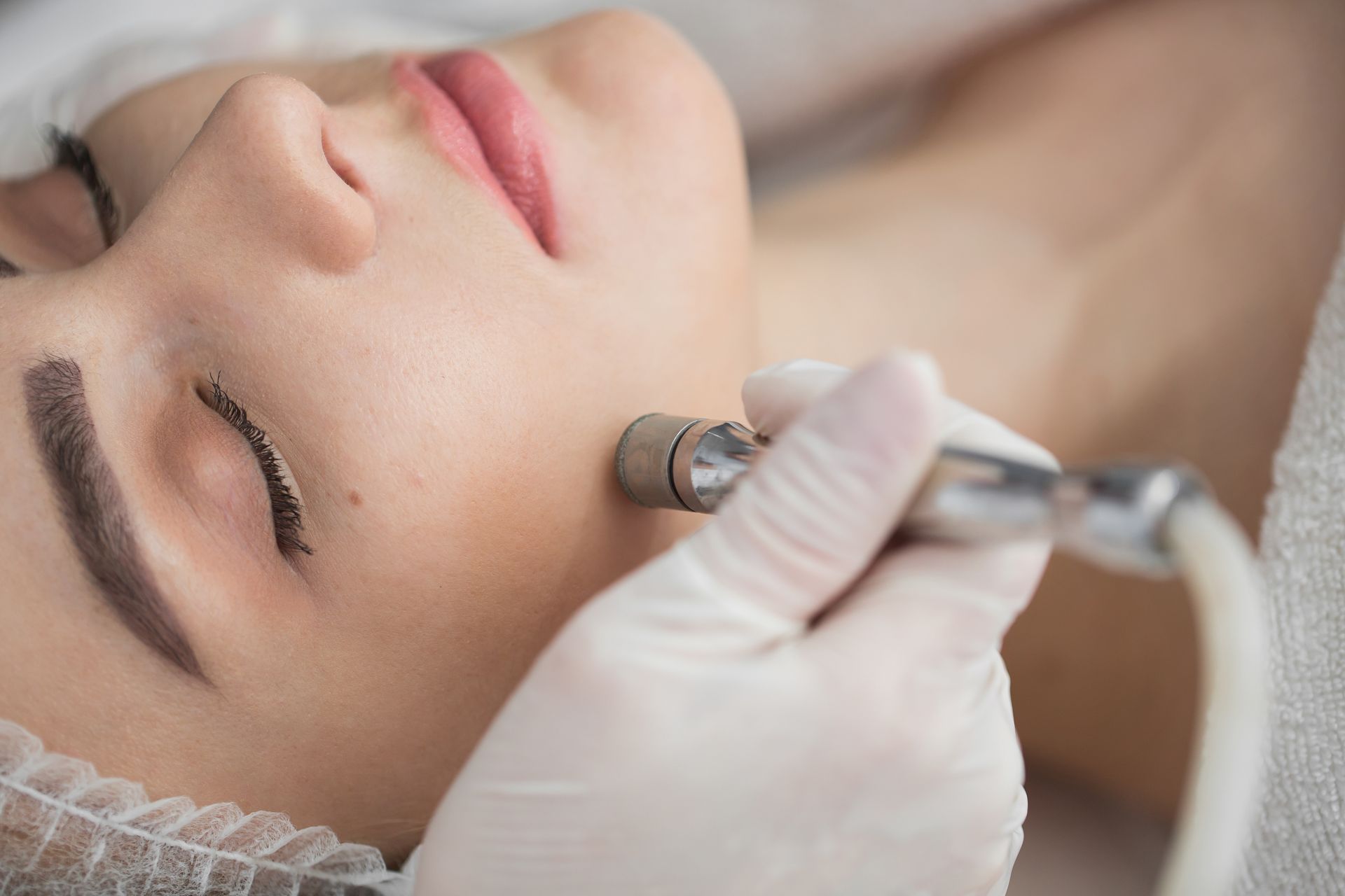 a woman is getting a facial treatment at a beauty salon .