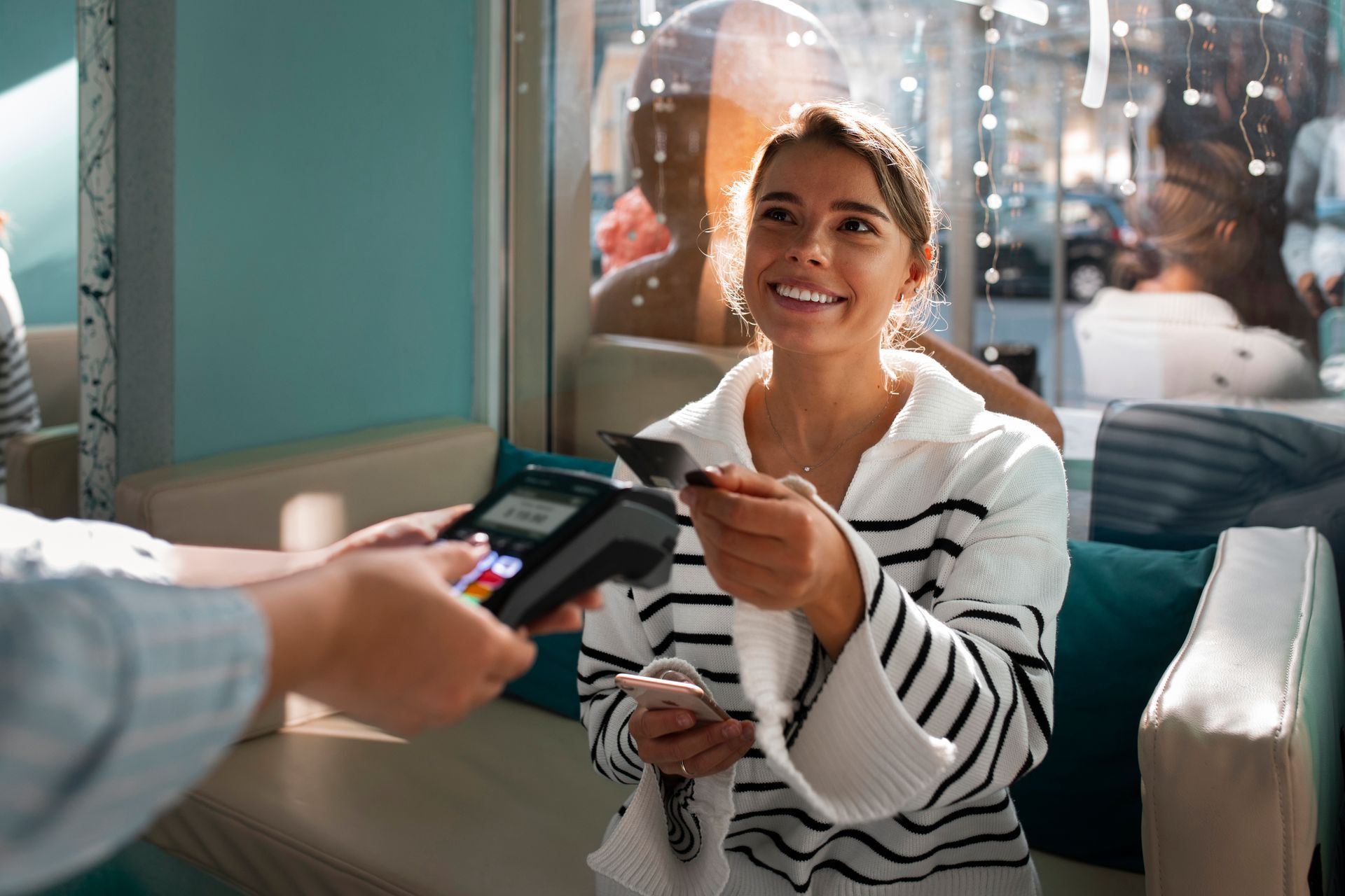 a woman is paying with a credit card in a spa .