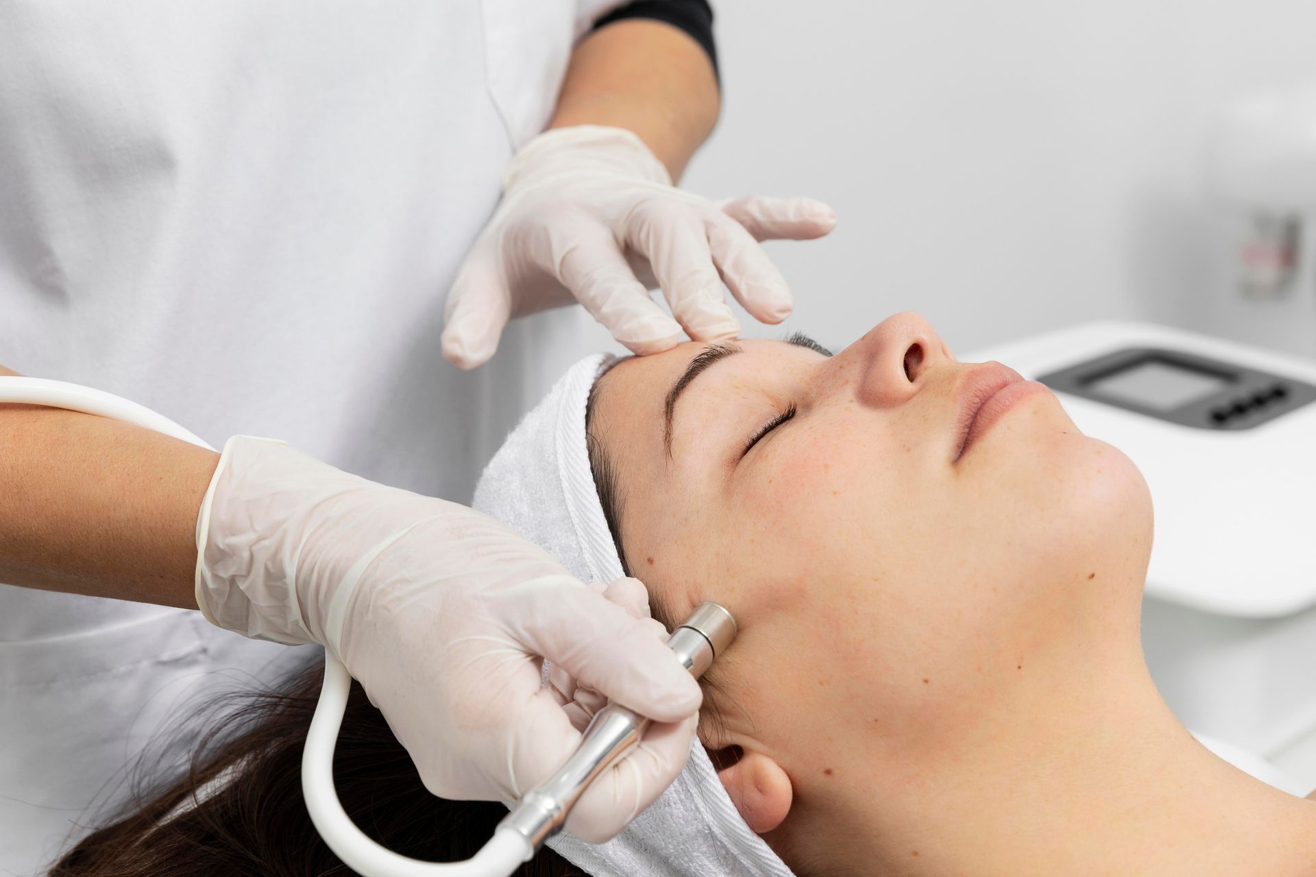 a woman is getting a facial treatment at a beauty salon .