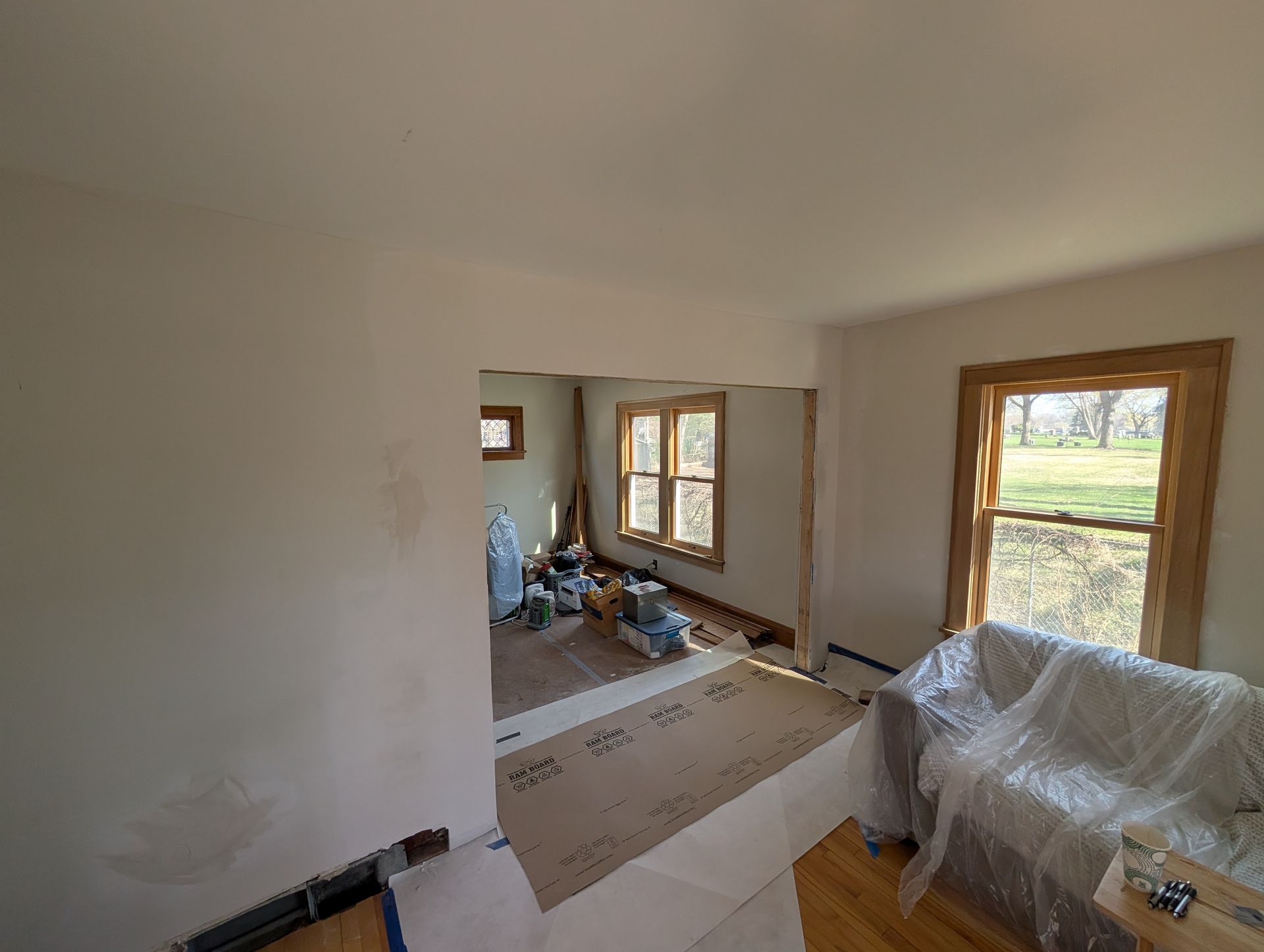 Widened kitchen and dining room opening in Golden Valley, MN, showing smooth plaster and drywall repairs ready for jamb and casing trim installation.