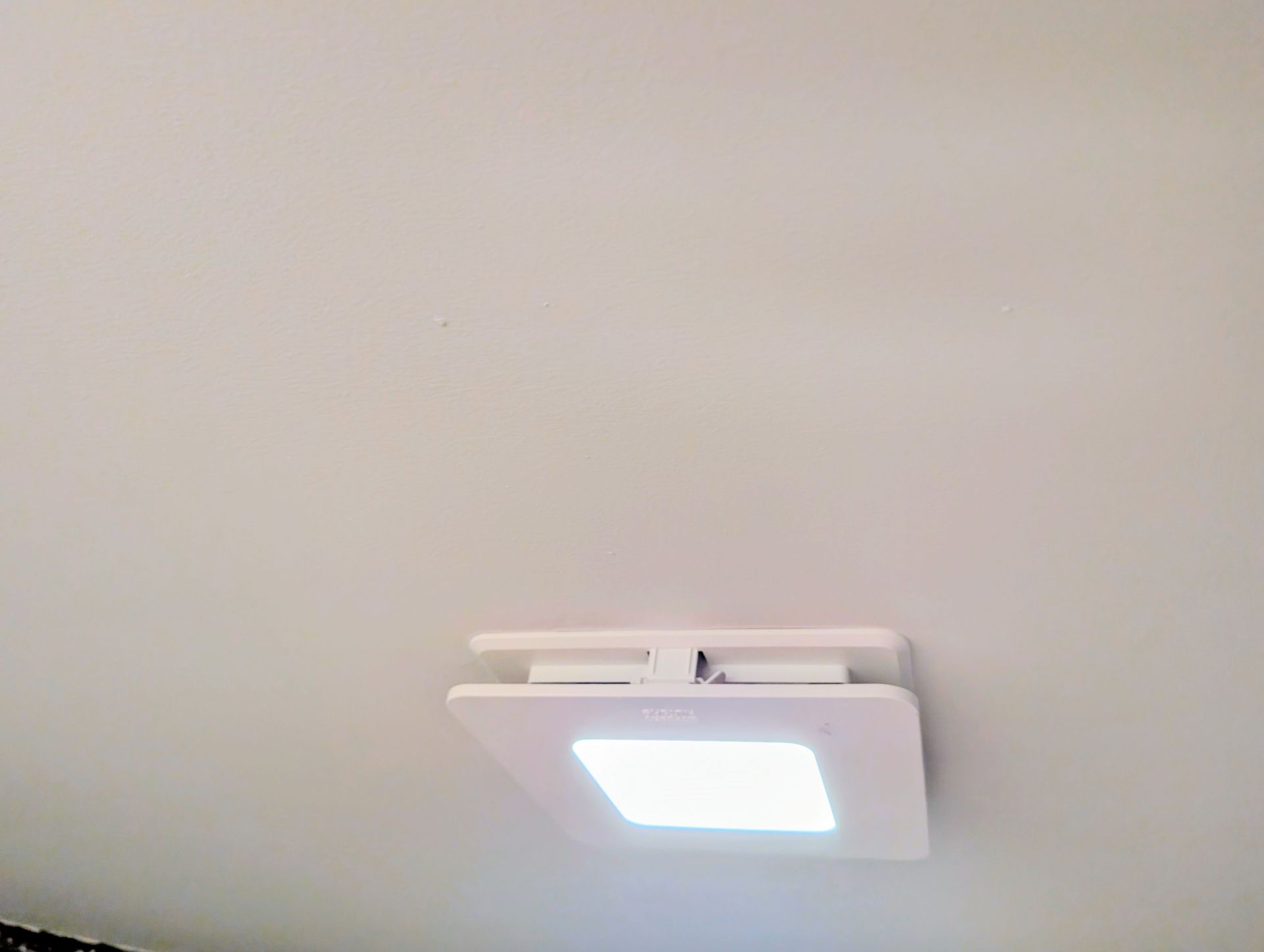 Finished bathroom ceiling in Coon Rapids, MN, showing a new exhaust fan, smooth painted drywall, and a clean finish after popcorn ceiling removal.