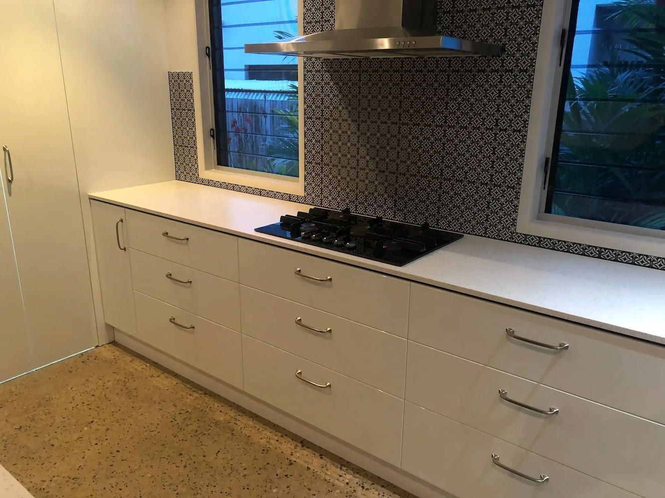 A Kitchen with White Cabinets and A Stove Top Oven — JWB Joinery in Aitkenvale, QLD