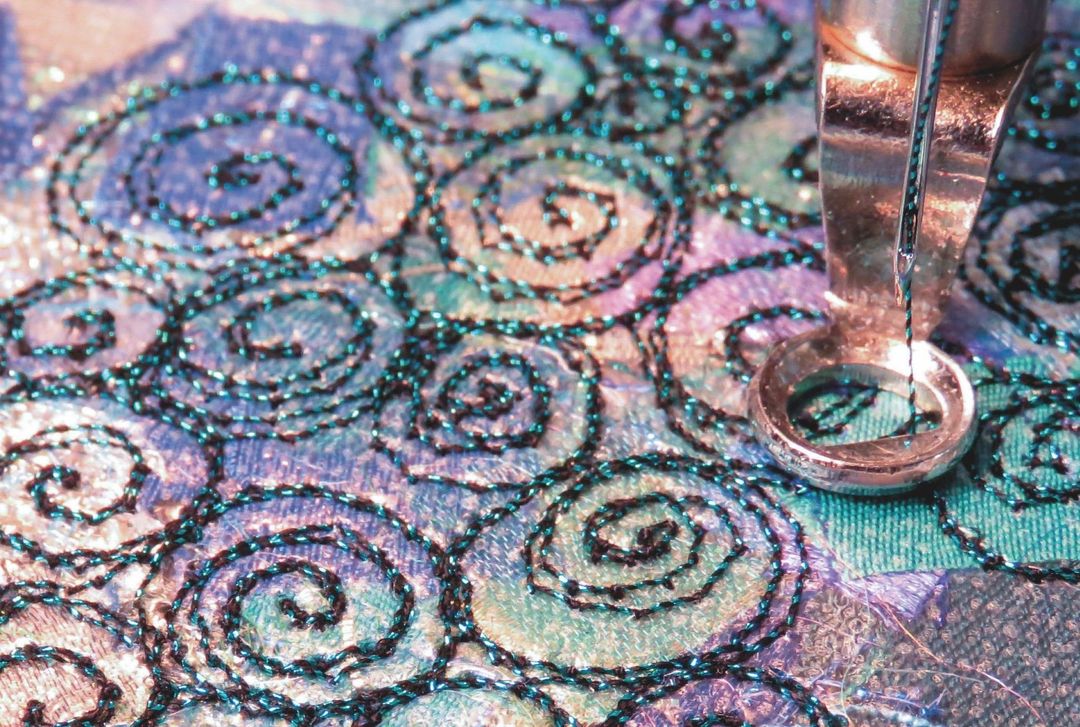 free machine embroidery spirals on snips of fabric and water soluble film