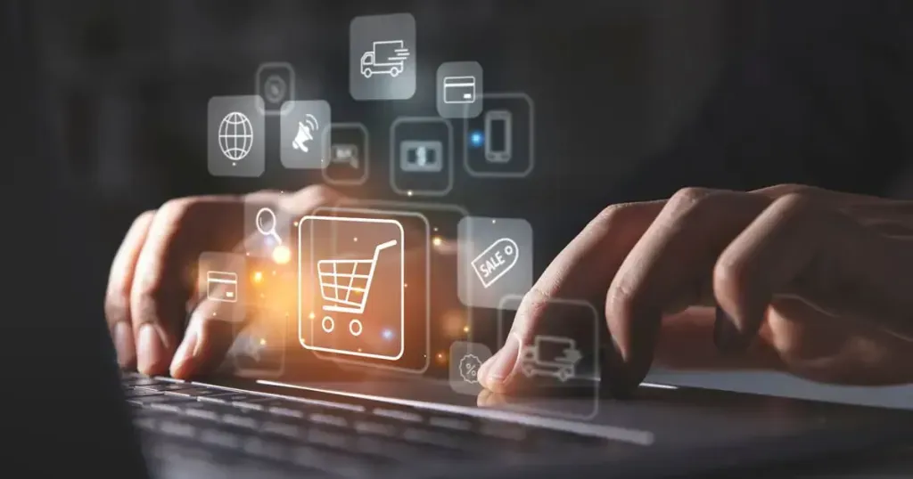 Des mains tapent sur un ordinateur portable avec des icônes holographiques représentant les achats numériques, le commerce et la livraison flottant au-dessus.