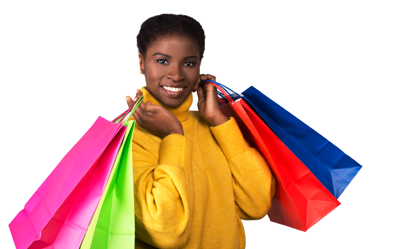 Une femme portant un pull jaune tient un tas de sacs de courses.