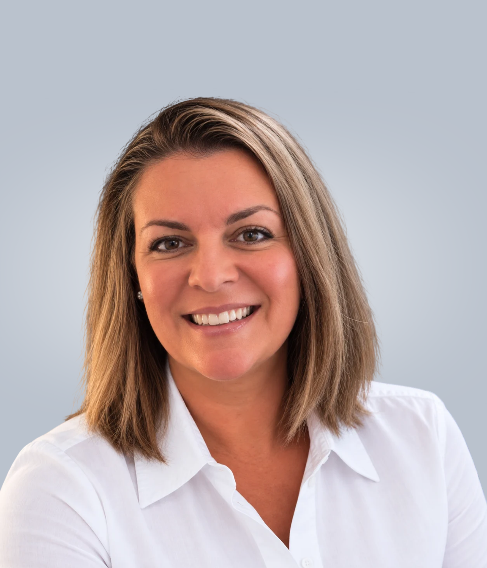 Smiling person in a white shirt against a light gray background.