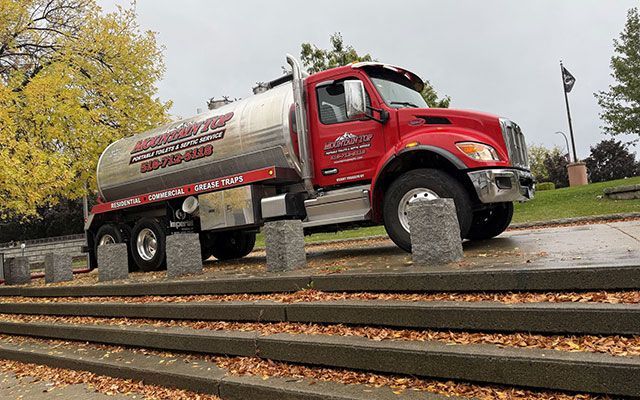 Red septic service truck with