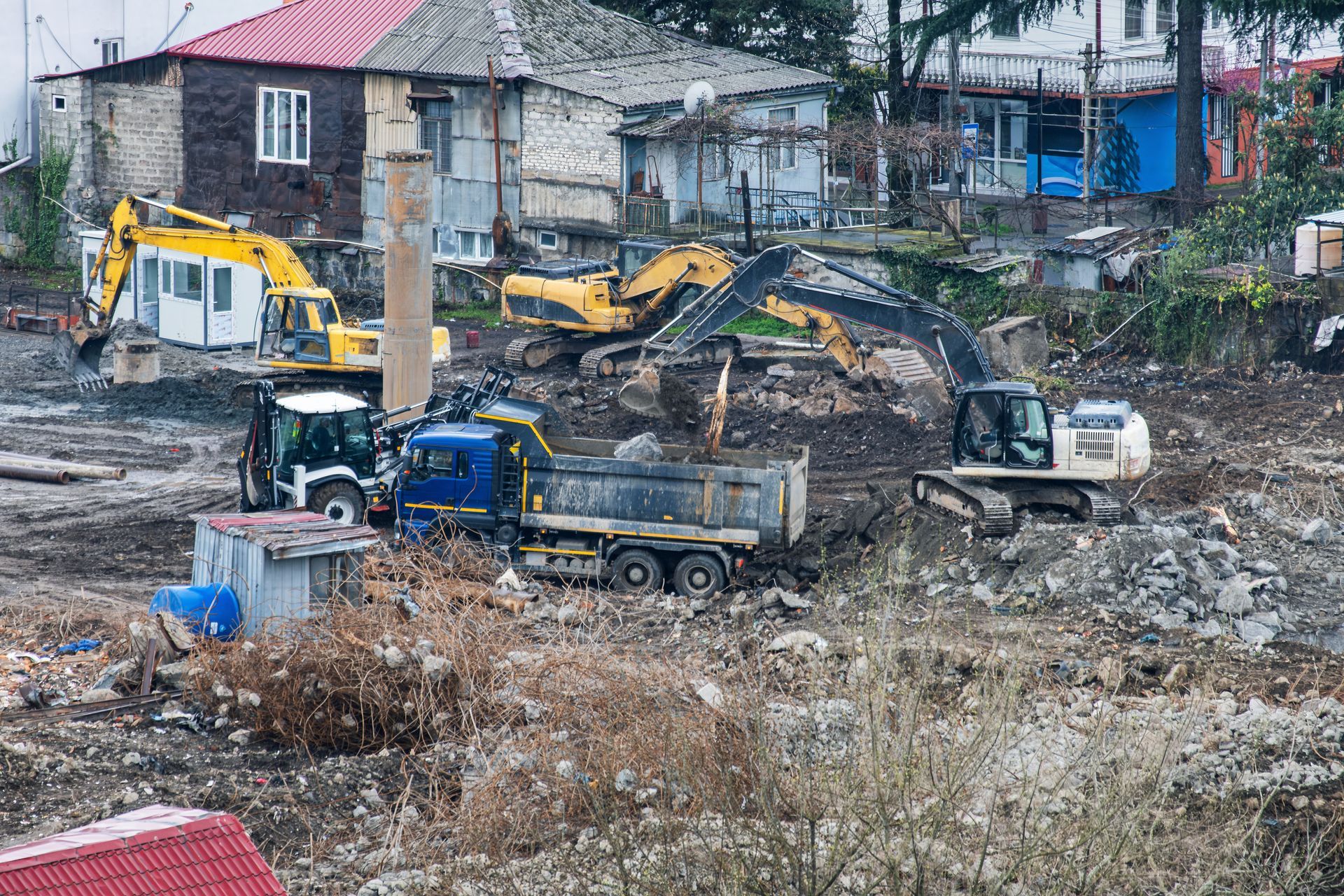 A construction site with several excavators.