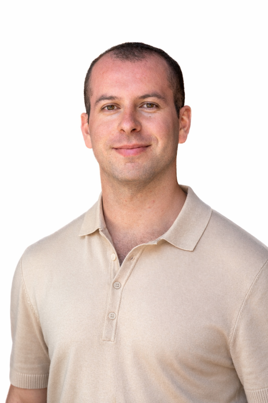 A man with a beard is wearing a white shirt and smiling.