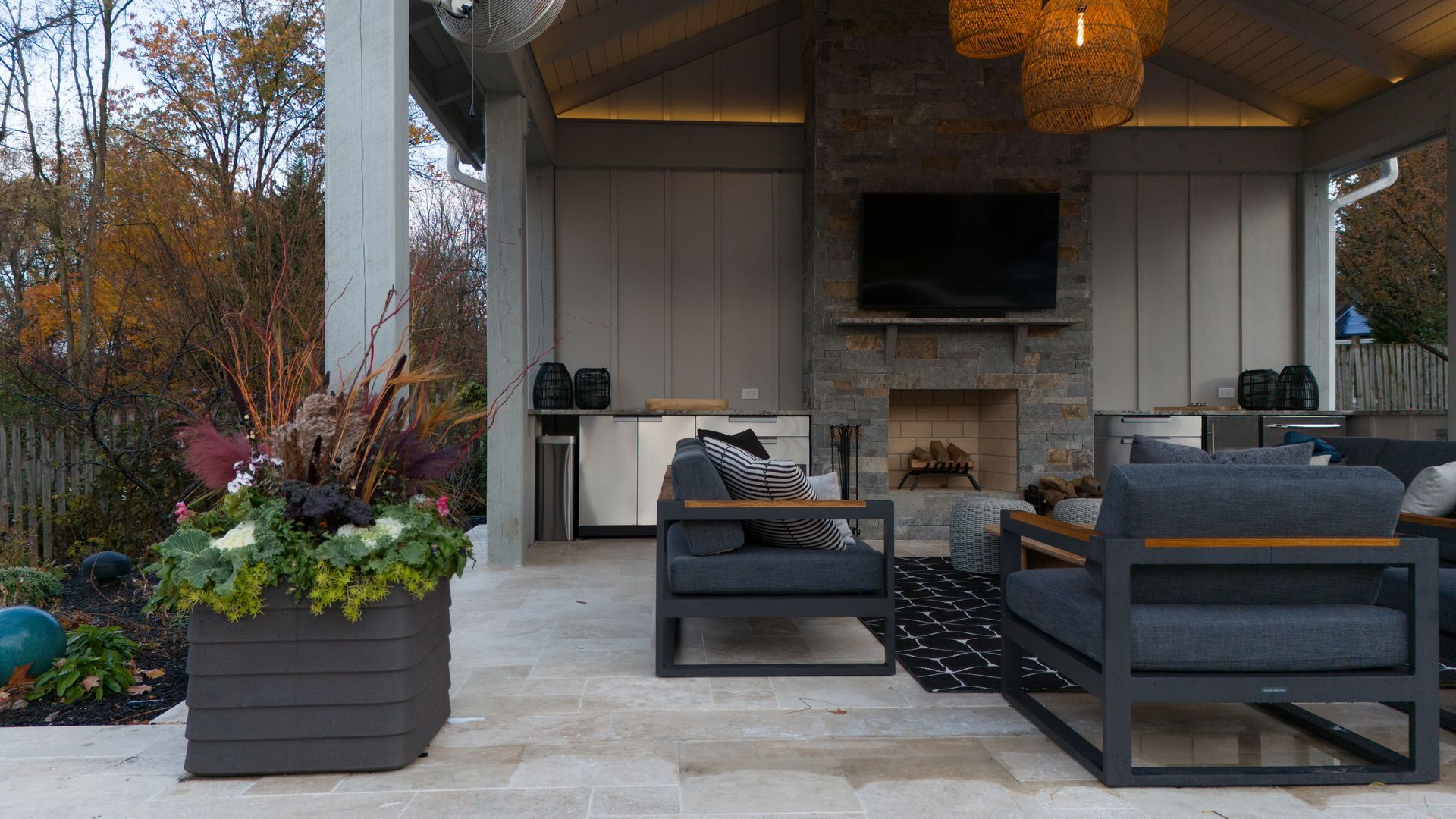 Outdoor patio with seating, fireplace, and built-in bar area.