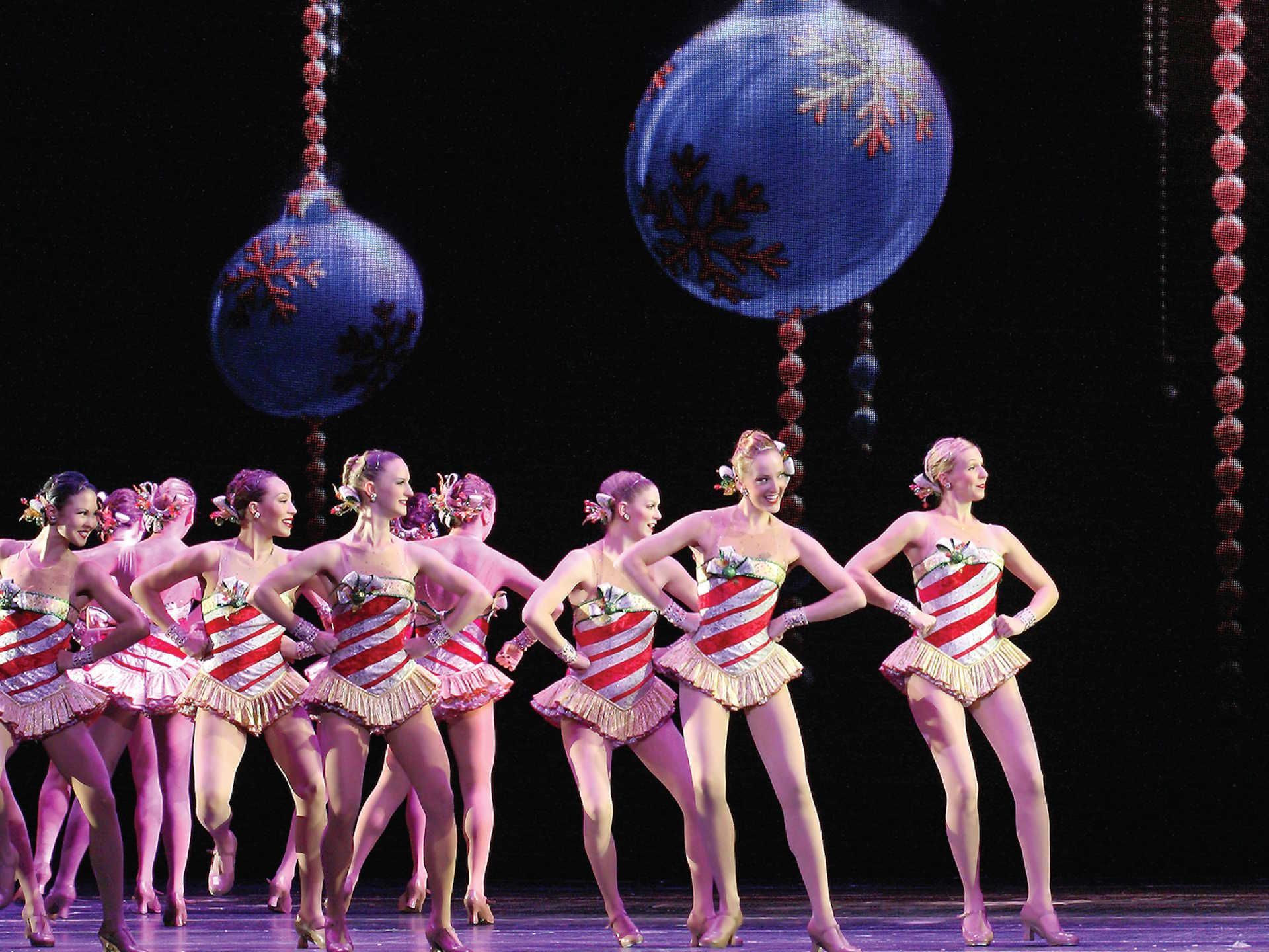 Radio City Music Hall Rockettes mid performance with arms on their hips