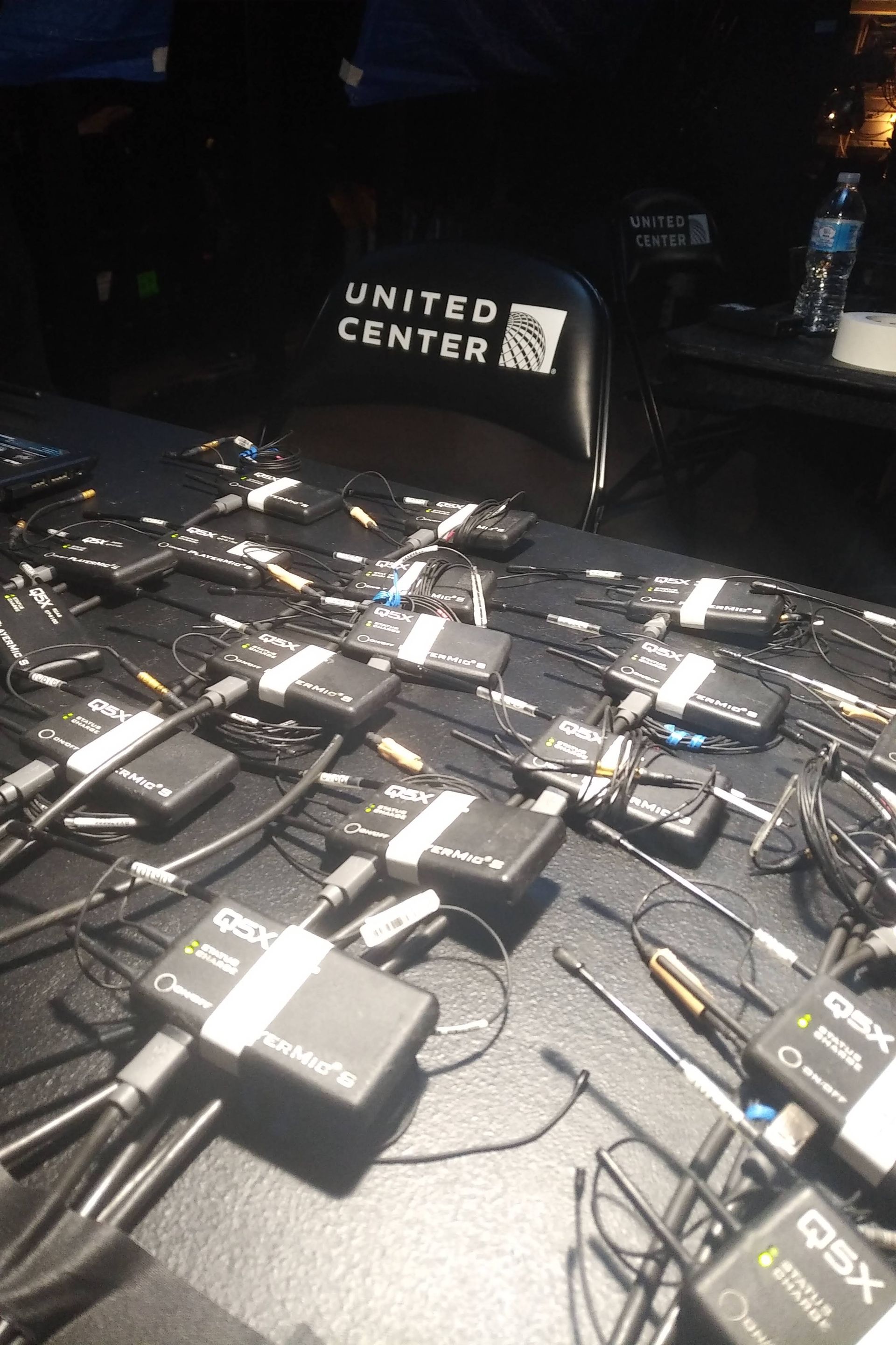 Q5X PlayerMics sitting on a table charging at the United Center