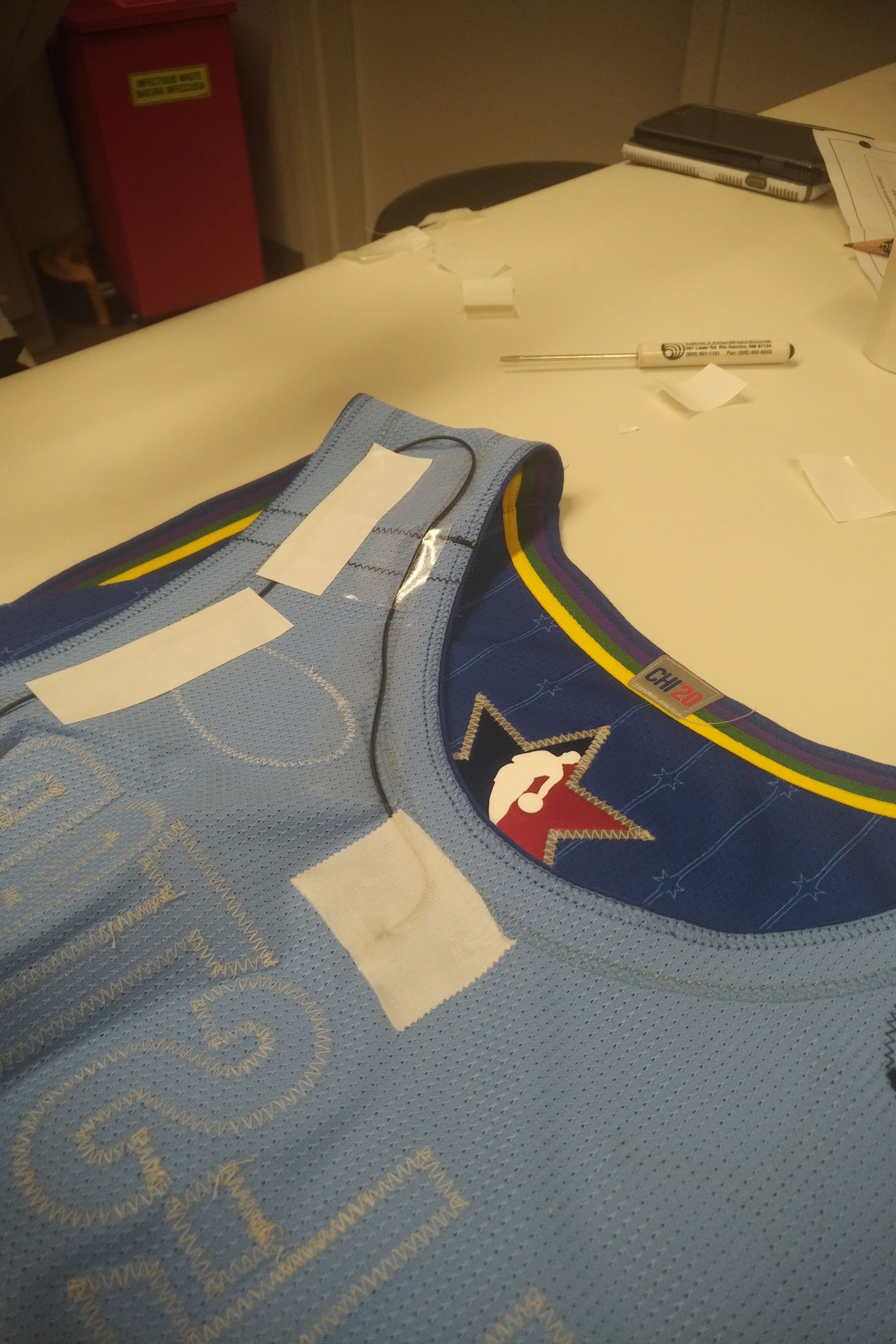 Q5X PlayerMic with microphone cable routed inside a Memphis Grizzlies NBA basketball jersey