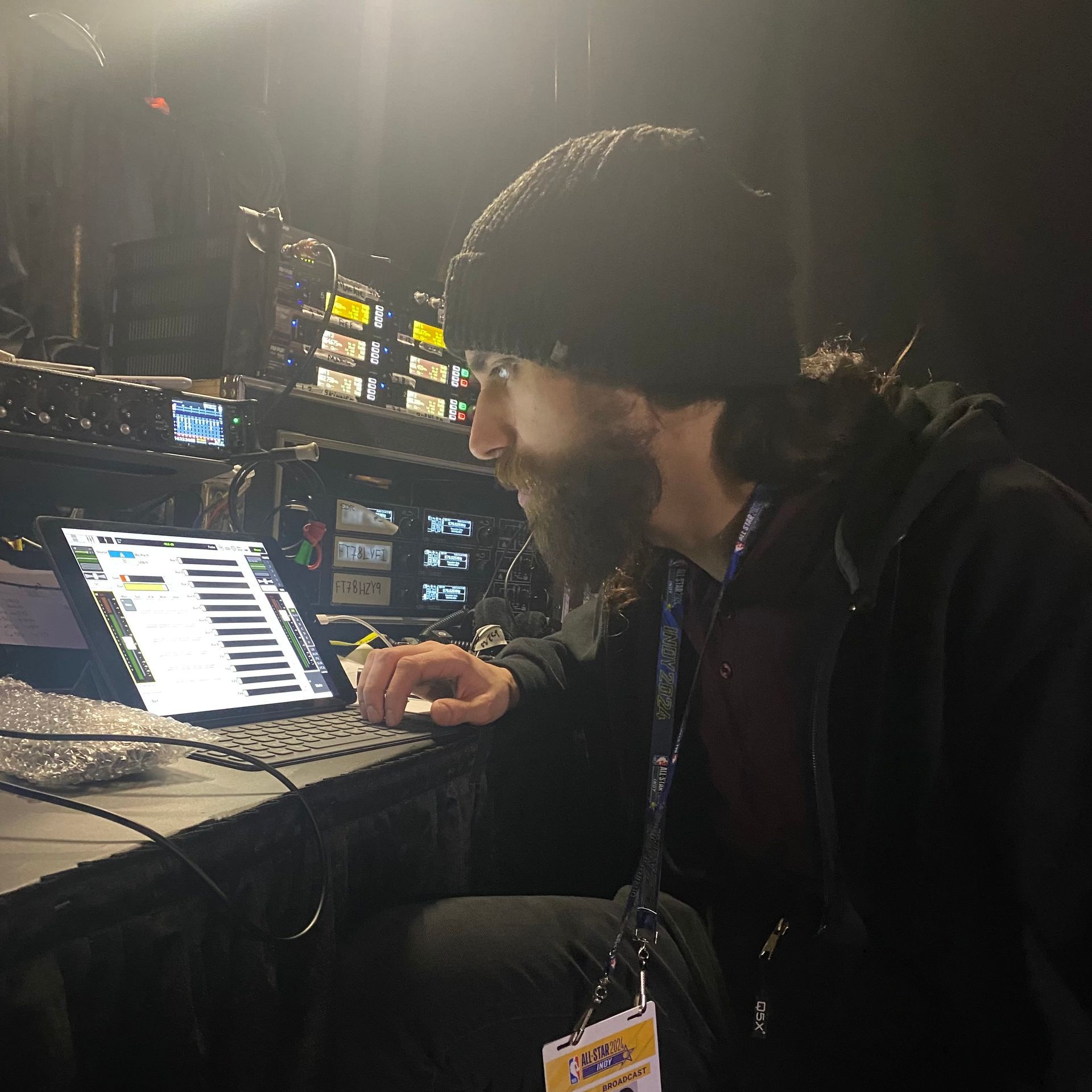 Q5X feild support technician analyzing gear backstage at NBA All Star game