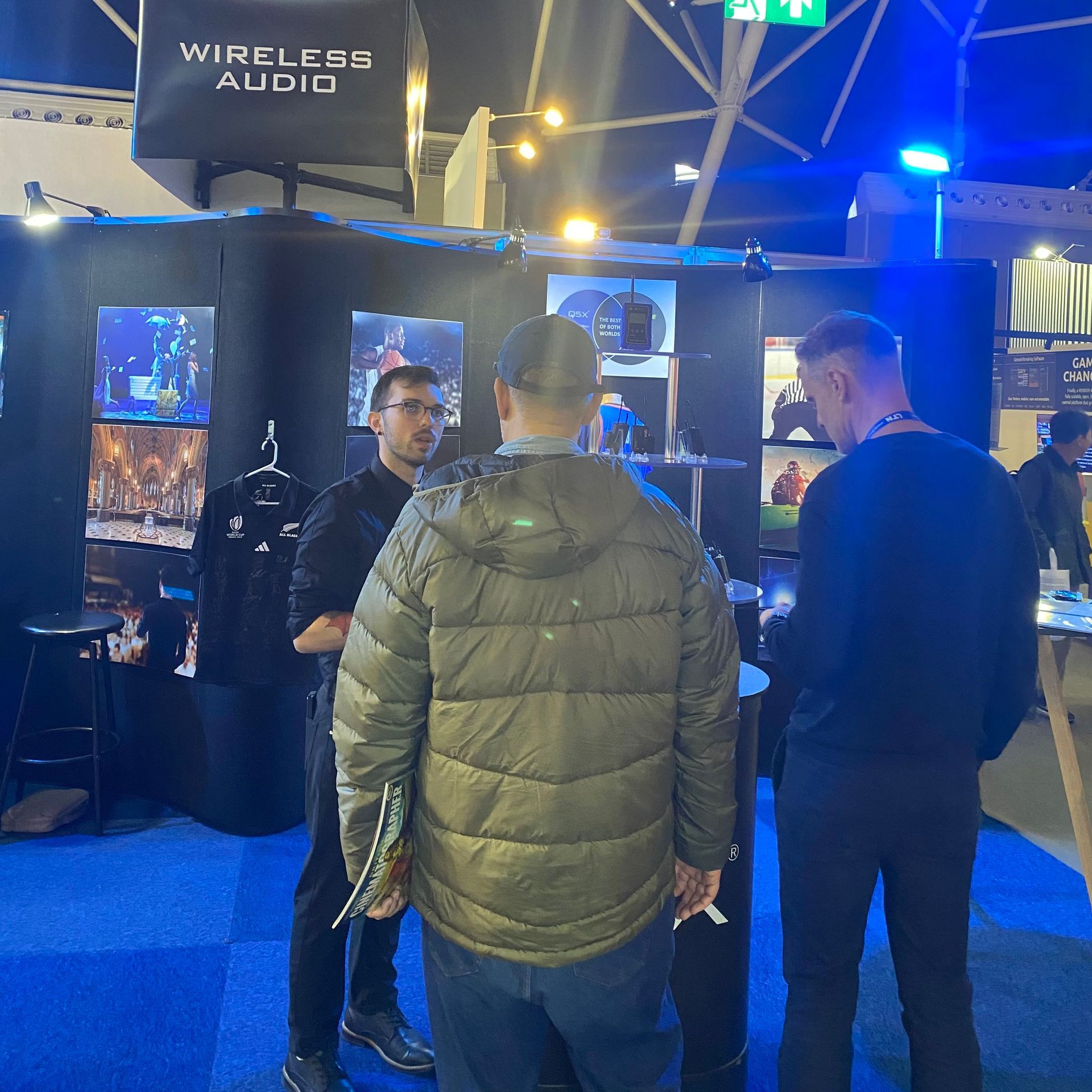 Q5X Customer Experience Manager explaining product features at NAB exhibition booth