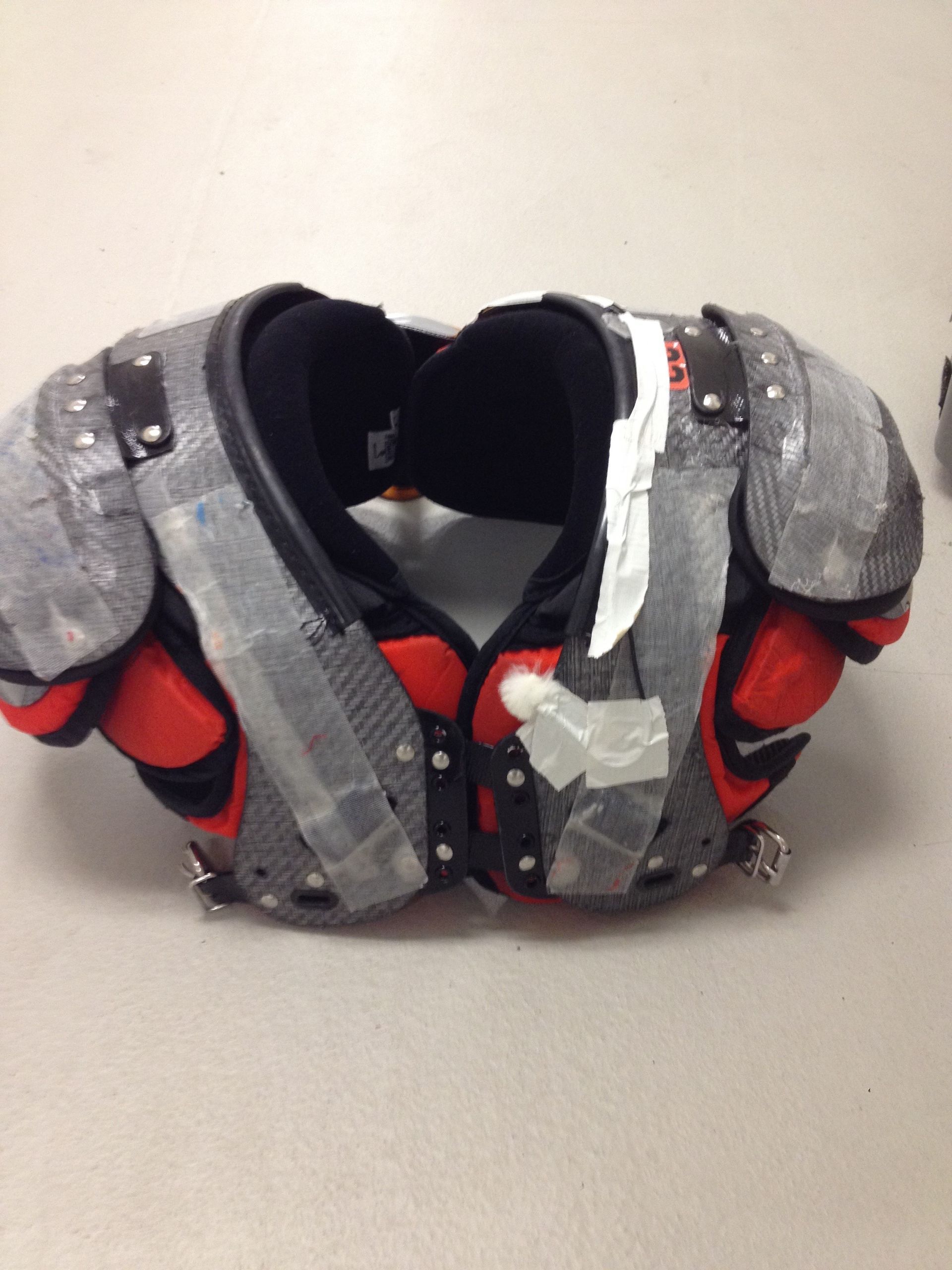 PlayerMic transmitter and microphone cable shown routed on shoulder pads