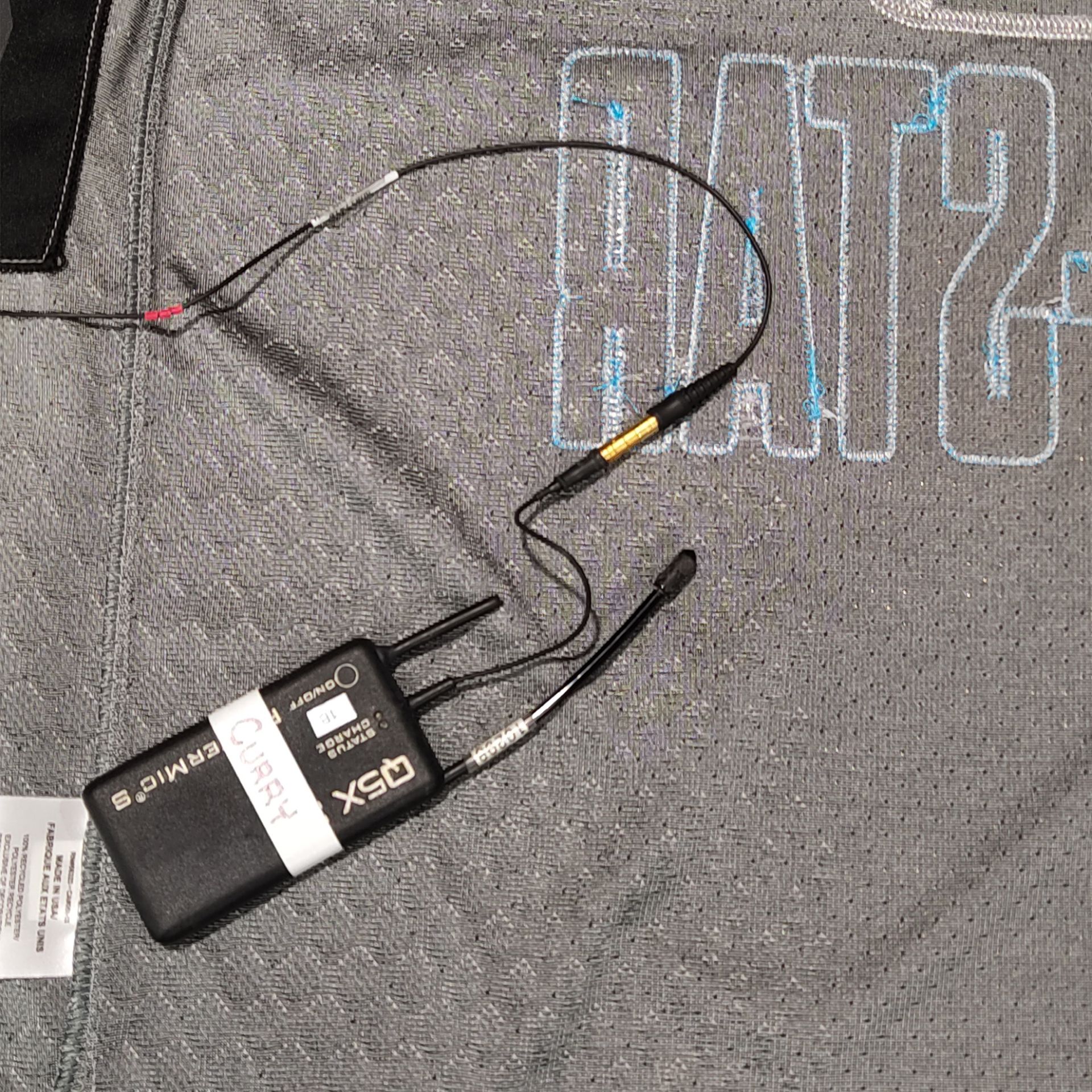 PlayerMic S and microphone cable shown routed under an NBA basketball jersey