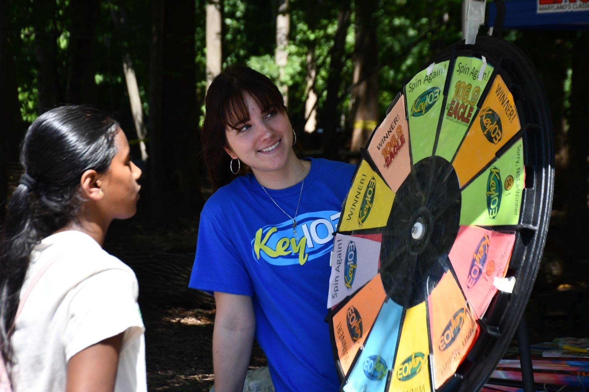 Girl with prize wheel at fundraising festival