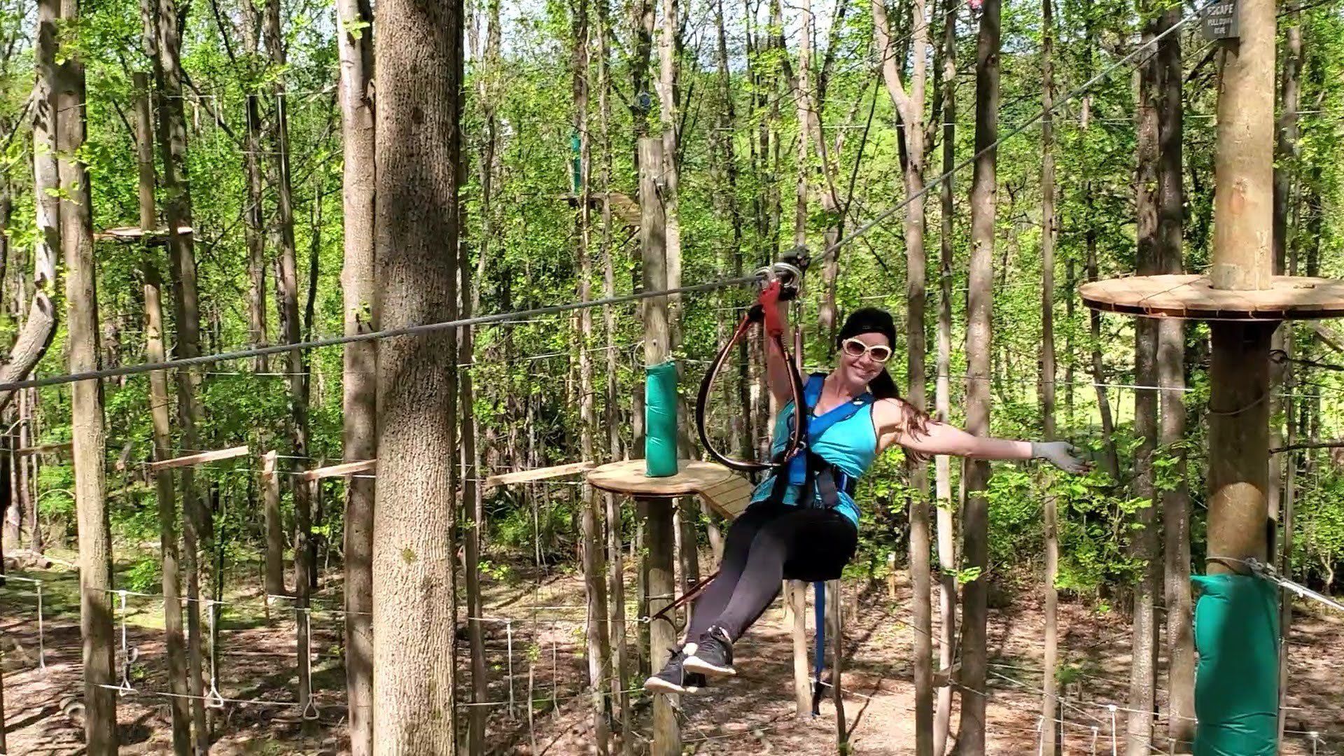 Adult women ziplining at Tree Trekkers aerial adventure and zipline park