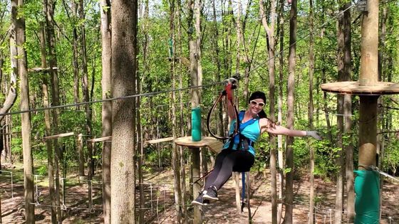 Adult women ziplining at Tree Trekkers aerial adventure and zipline park