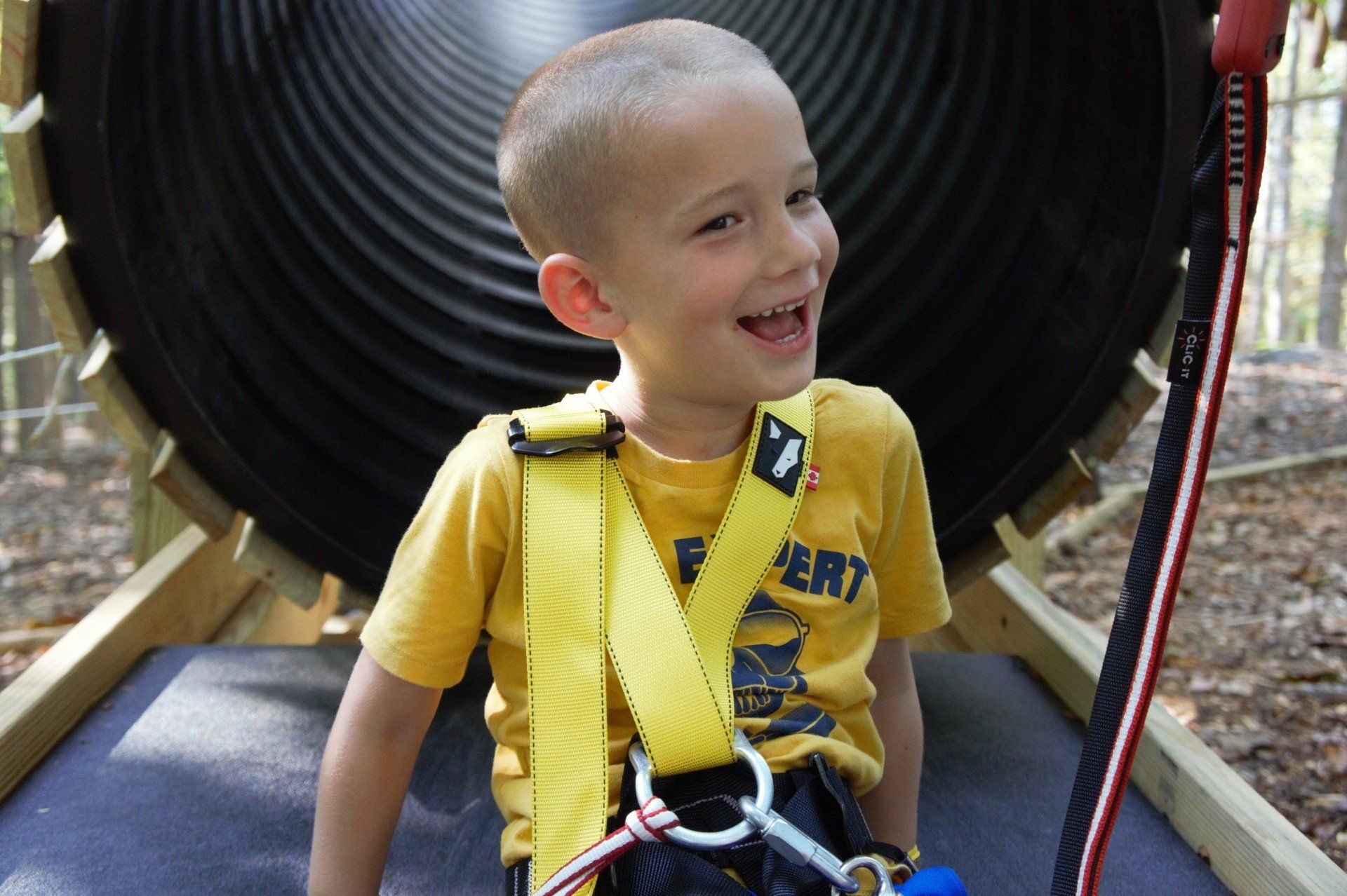 Young boy smiling after going down a slide