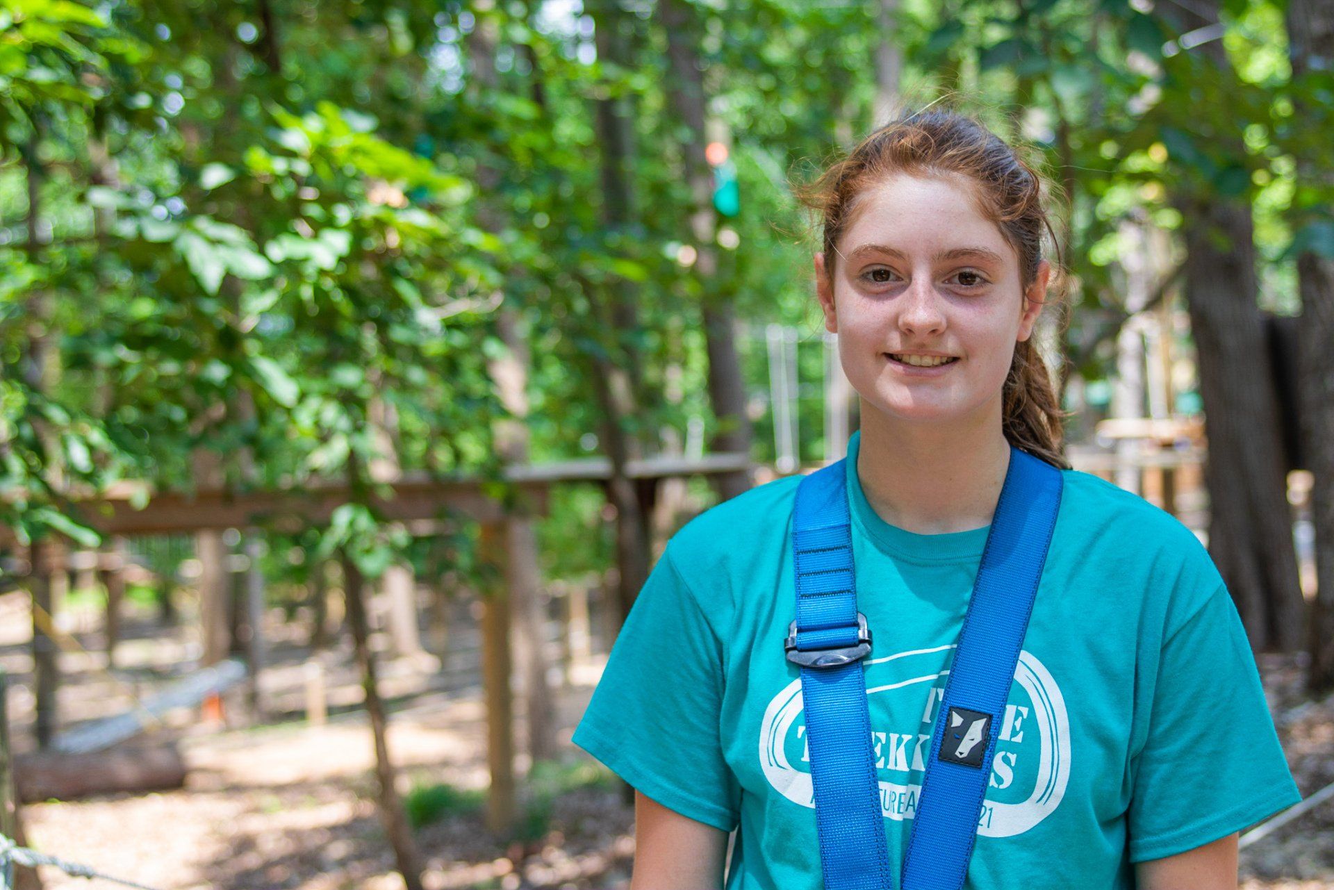 Adolescent female in climbing harness