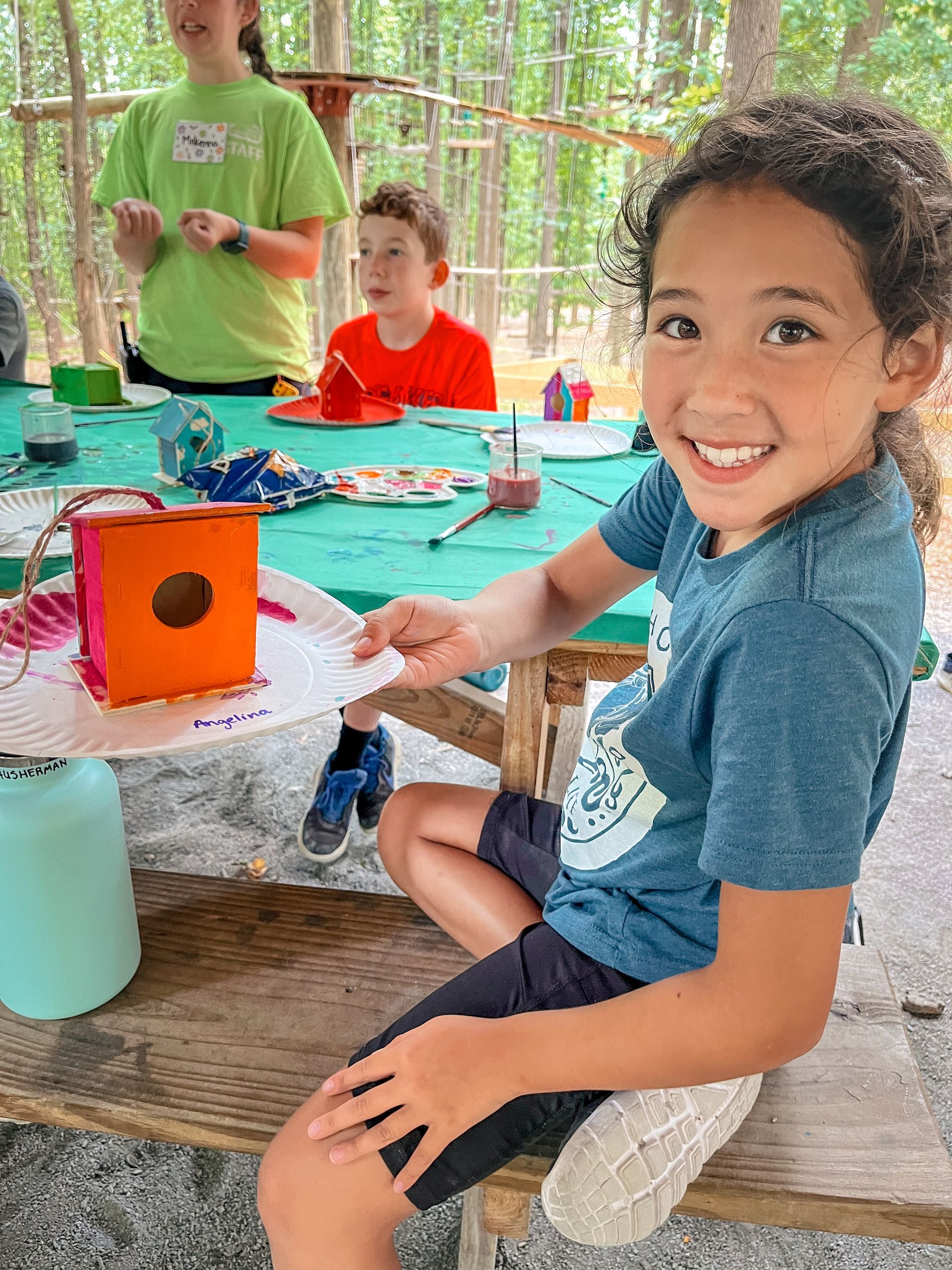 Young female camper participating in camp art craft