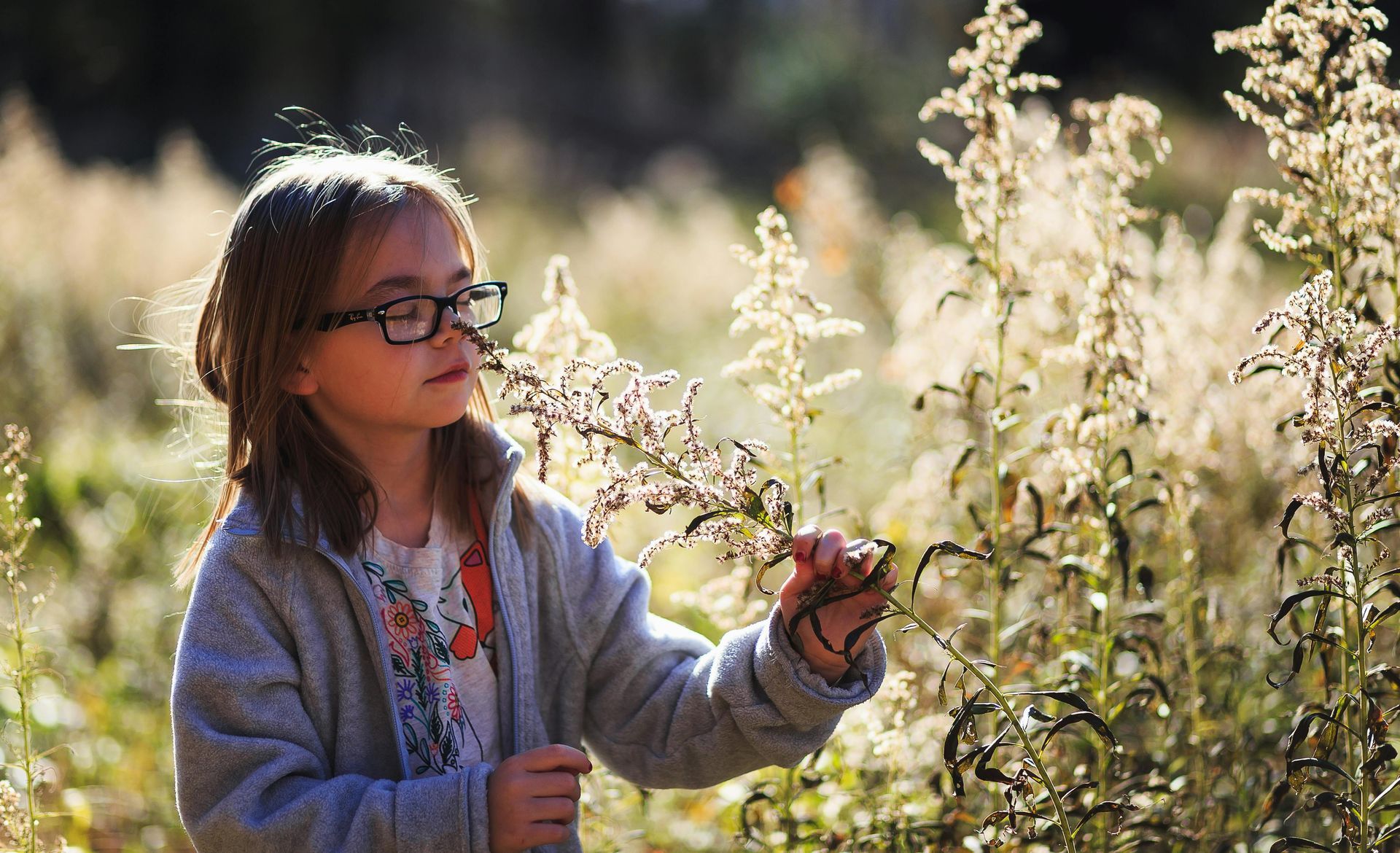 Kid smelling a flower - ABA Therapy for Autism