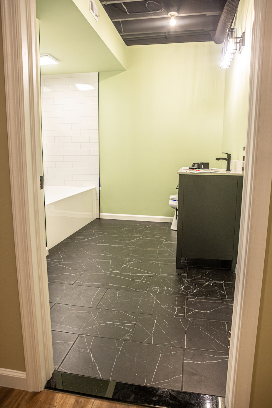A bathroom with a sink , toilet and bathtub.
