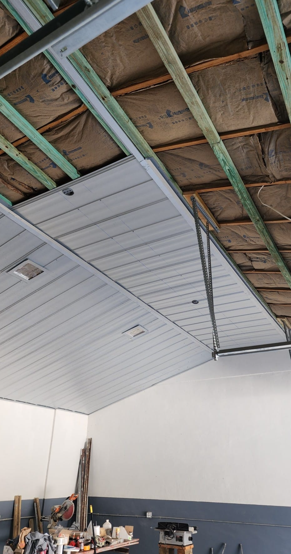 The ceiling of a garage is being remodeled.