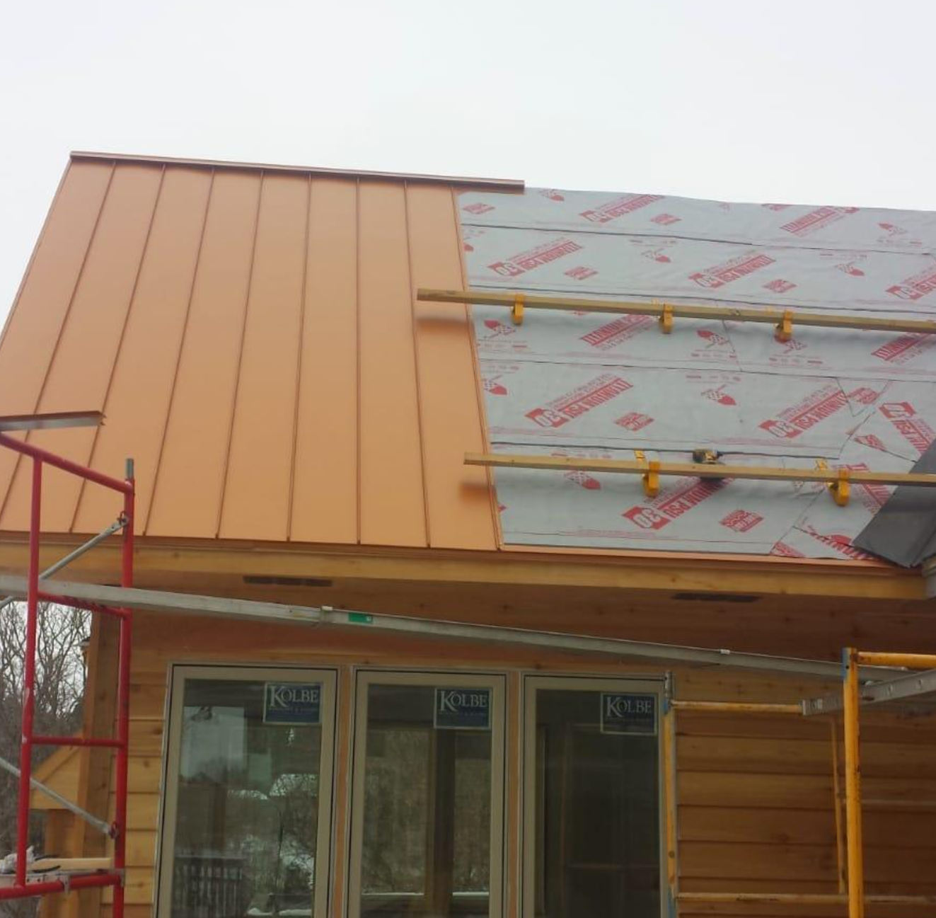 A house with a copper roof is being built