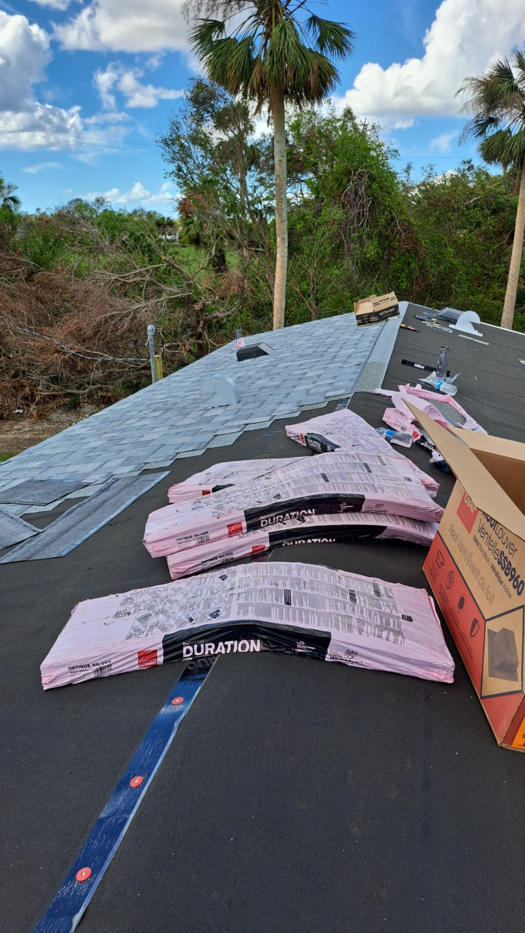 A roof is being built and there are a lot of pieces of insulation on the ground.
