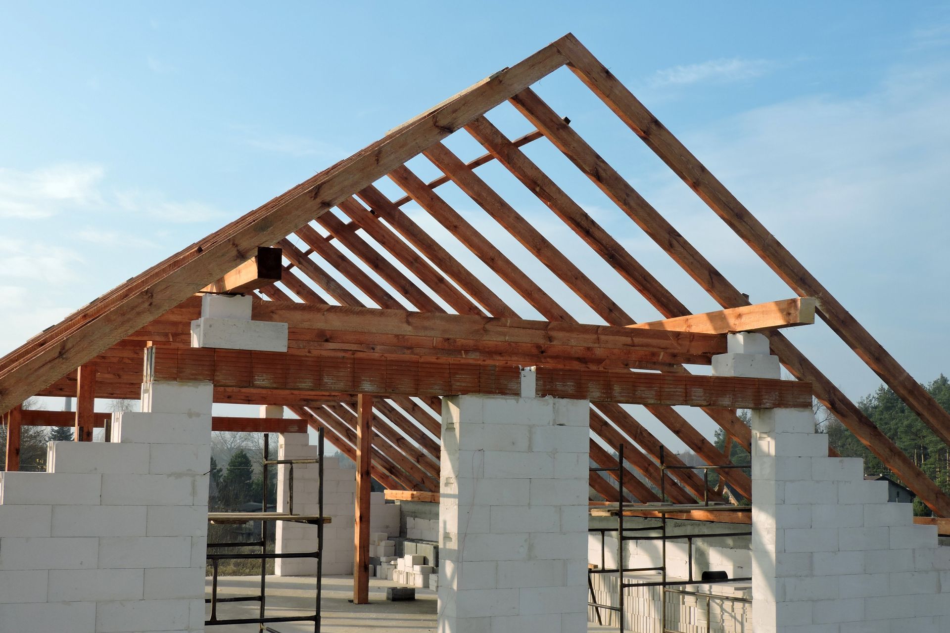 The roof of a building is being built with wooden beams