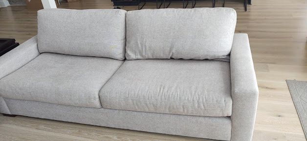 Gray sofa restored with professional upholstery cleaning services