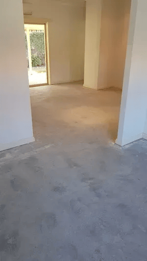 An Empty Room with A Concrete Floor and A Sliding Glass Door — TNT Floor Removal & Demolition in Tewantin, QLD
