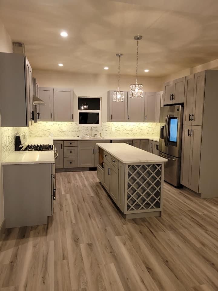 A large kitchen with a large island in the middle
